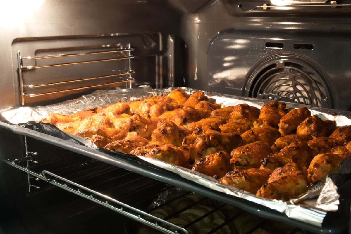 wings in a an oven on a baking sheet