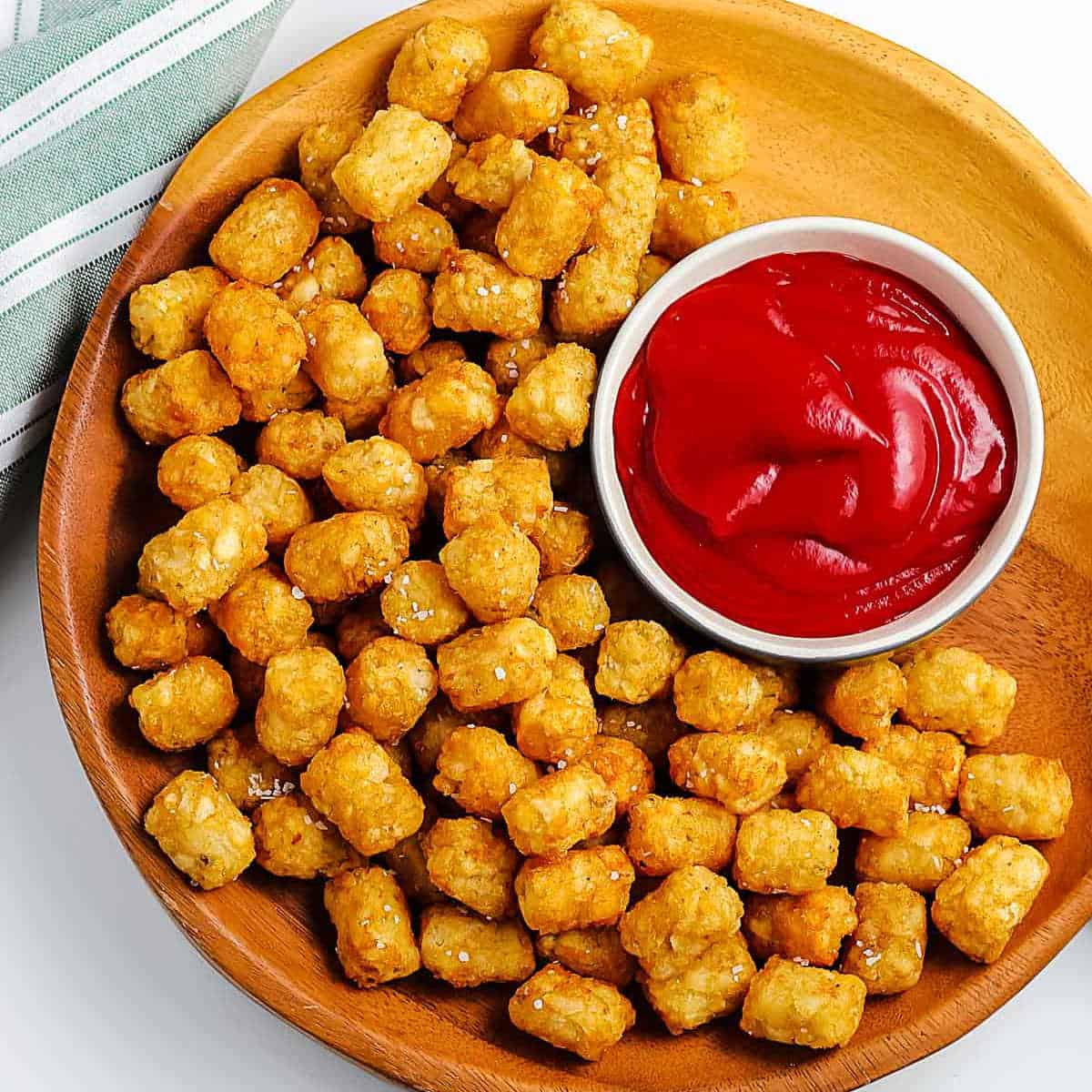 overhead picture of tater tots on a wood platter
