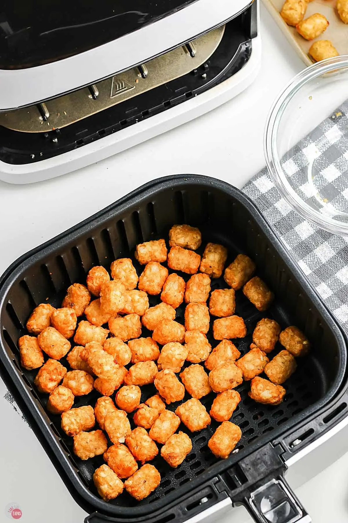 crispy tater tots in an air fryer basket