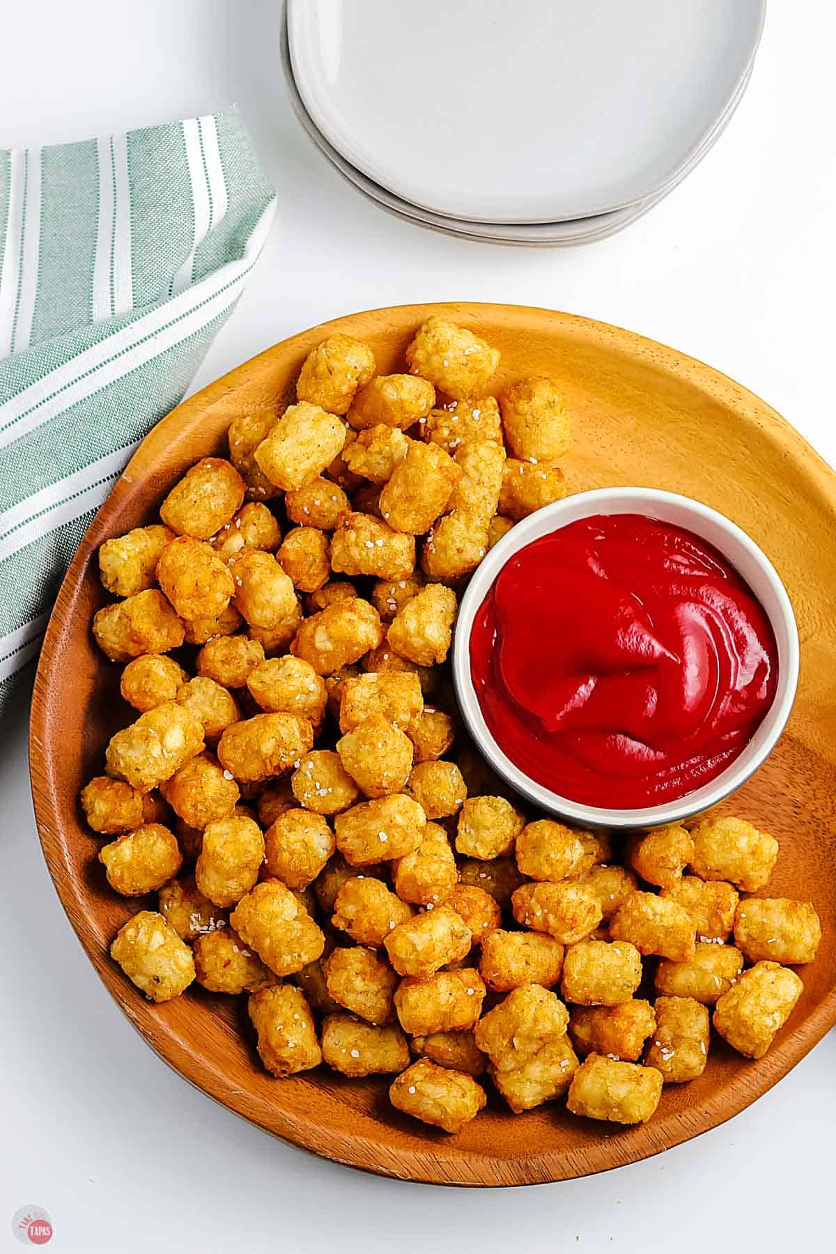 overhead picture of tater tots on a wood platter