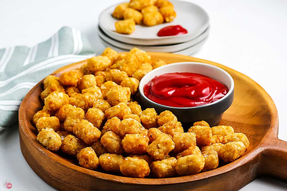 tray of tater tots and a bowl of ketchup