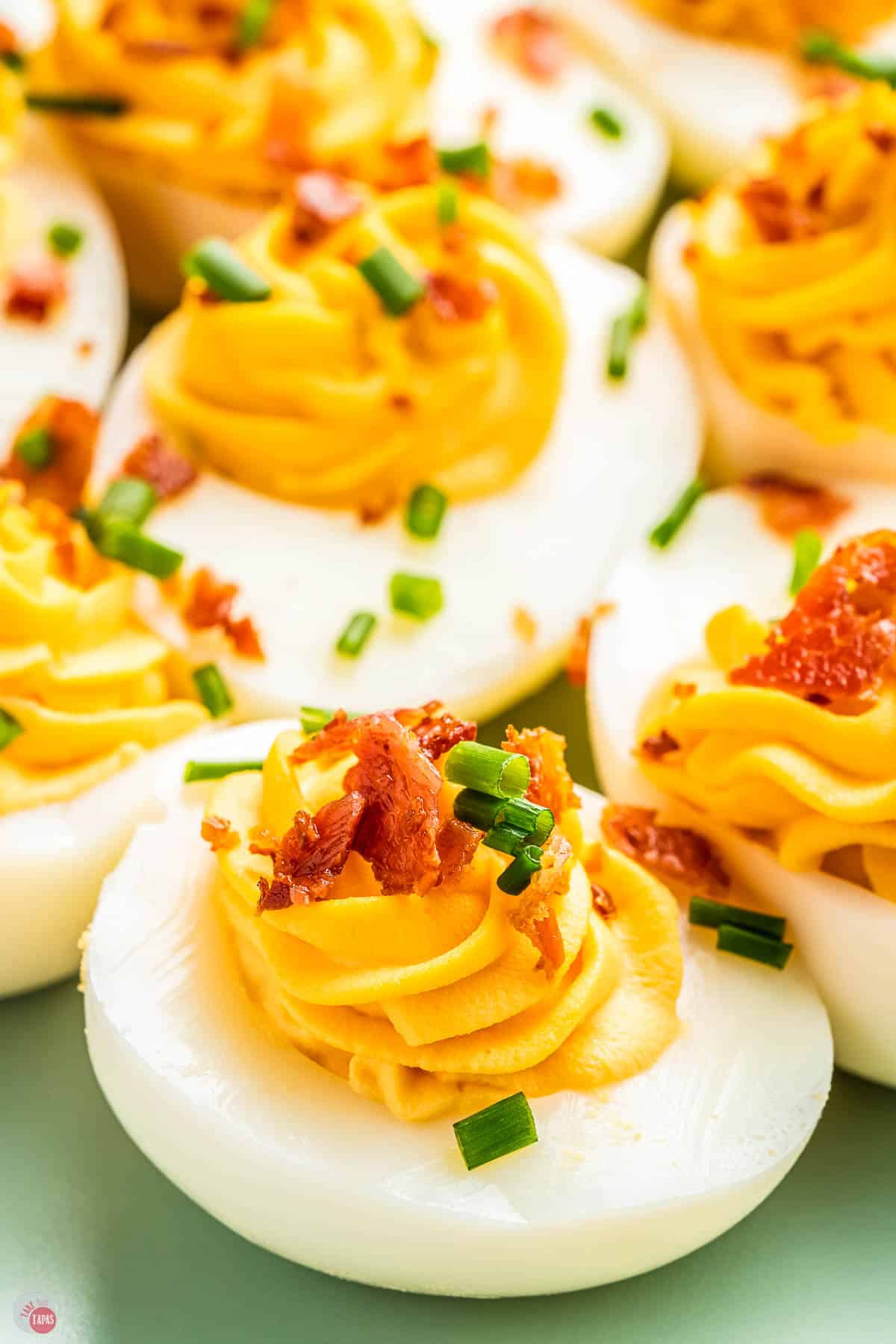 deviled eggs with bacon on a plate