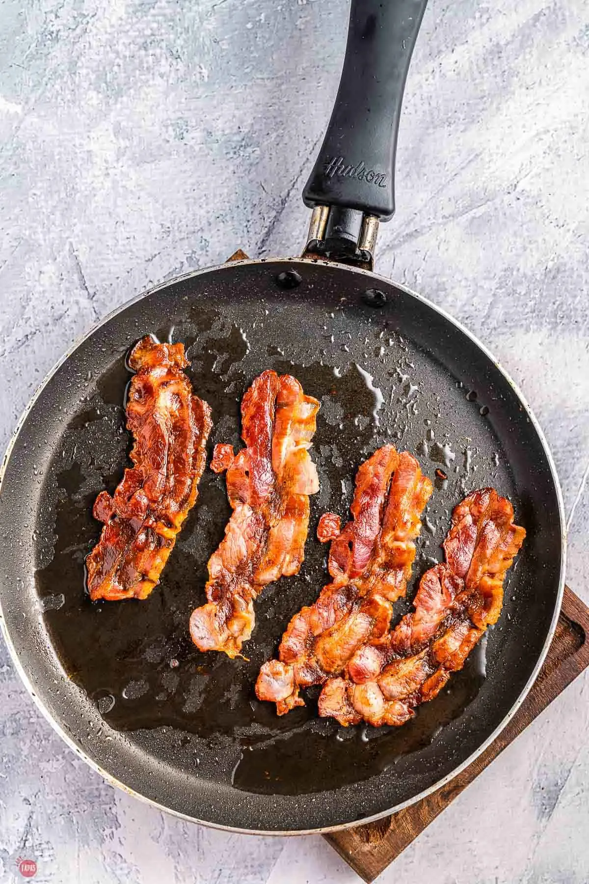 bacon sizzling on a pan