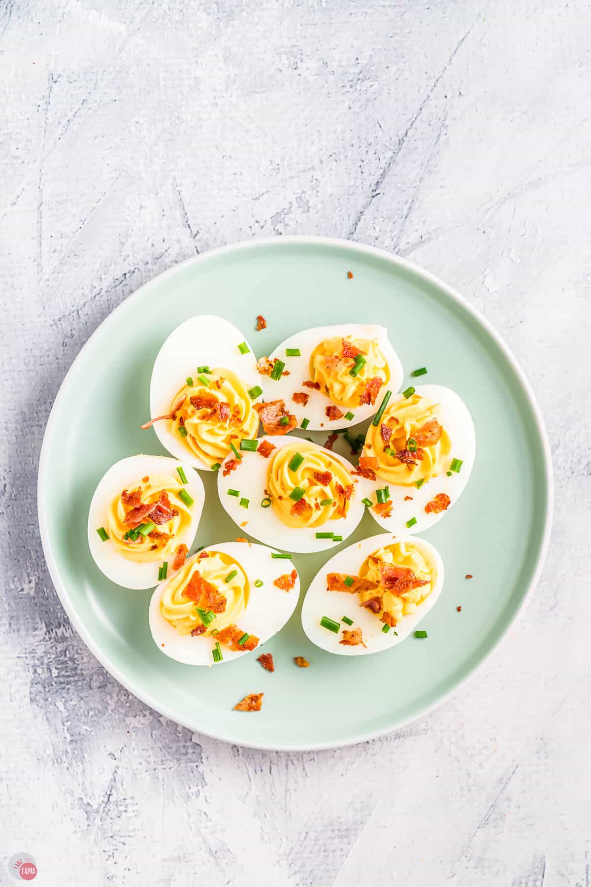 overhead picture of blue plate with bacon deviled eggs on it