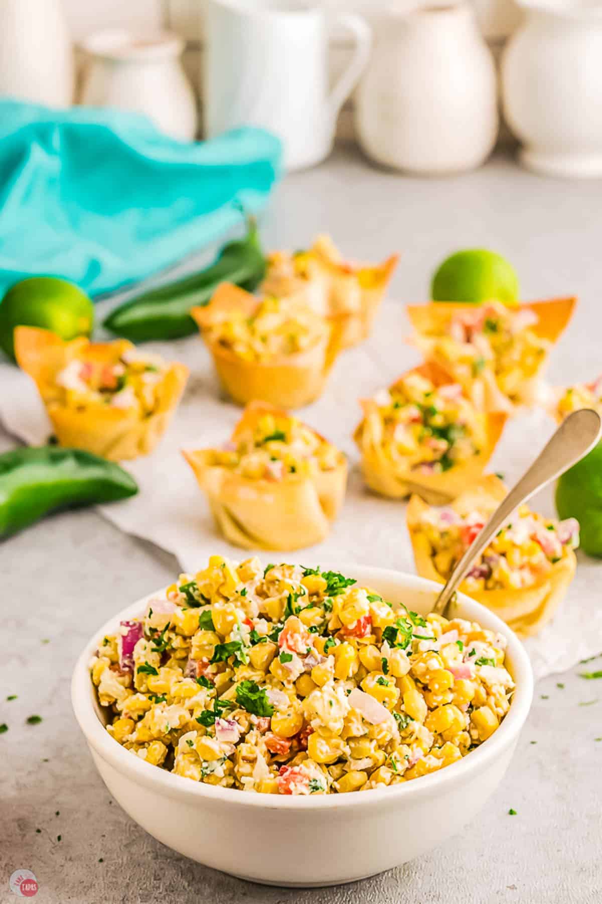small bowl of corn next to wonton cups