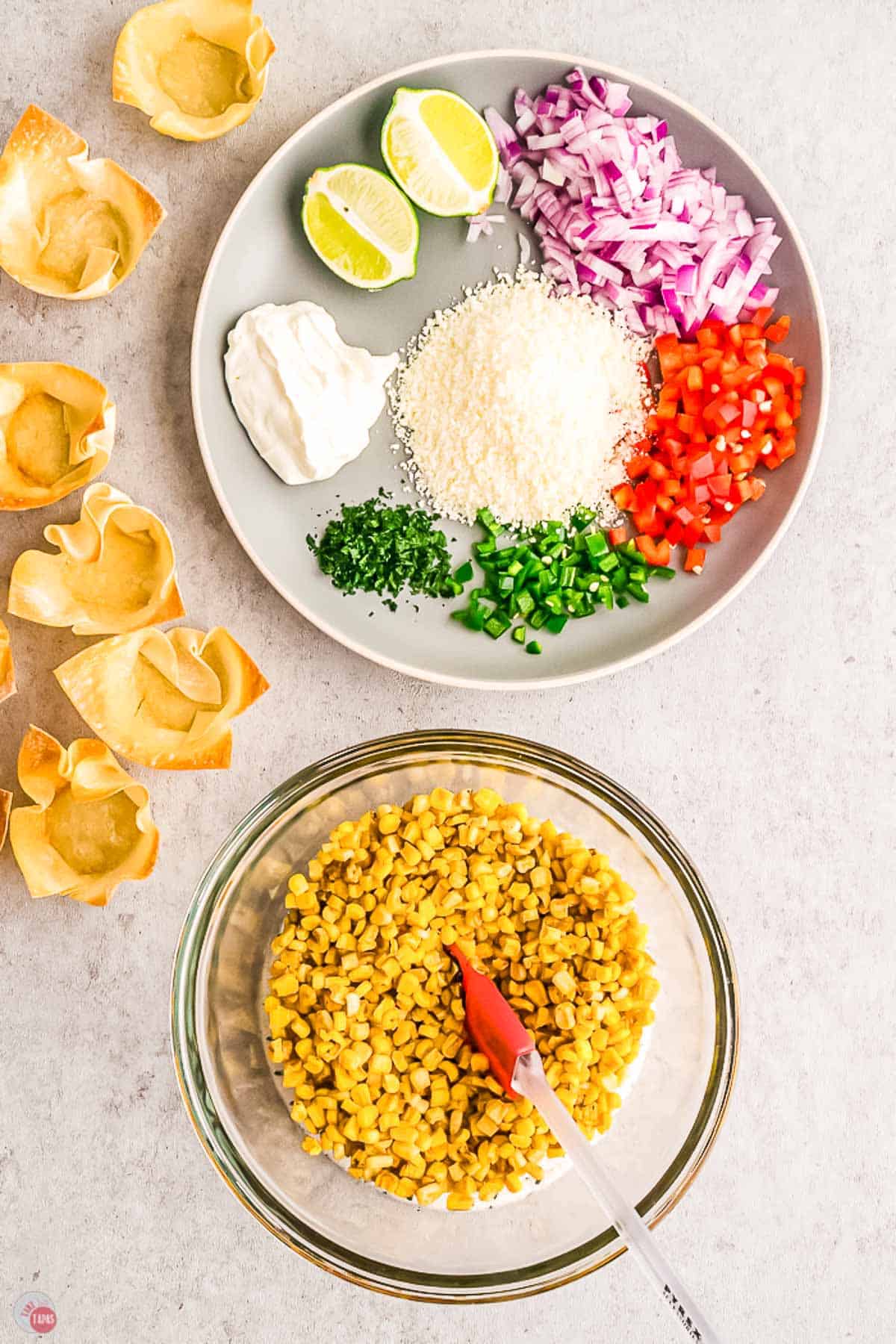 bowl of corn with a plate of chopped vegetables