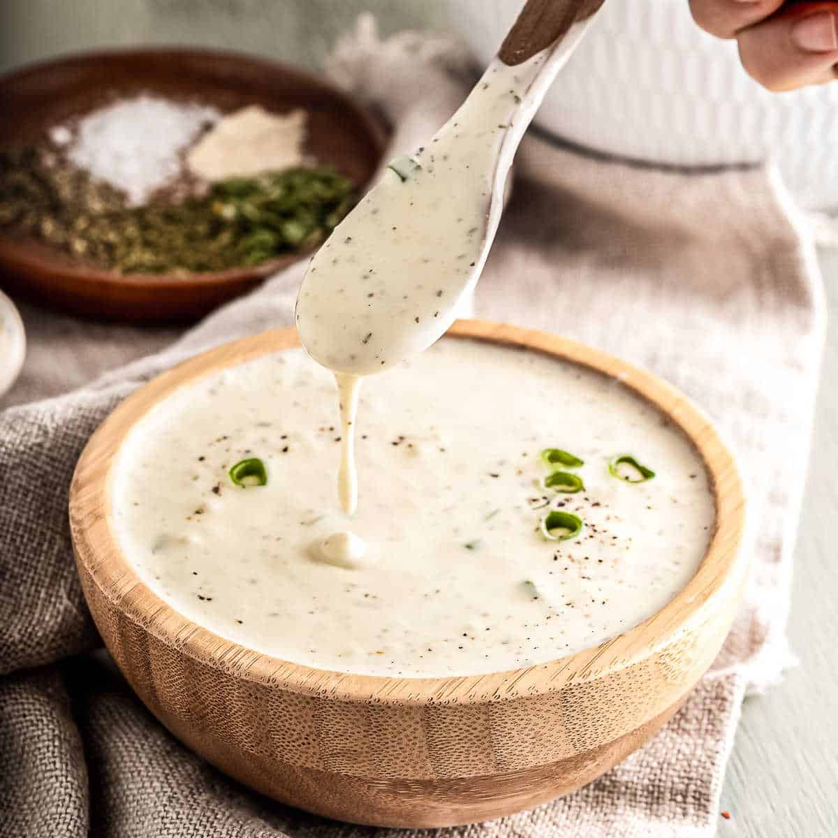ranch sauce in a wood bowl with a spoon