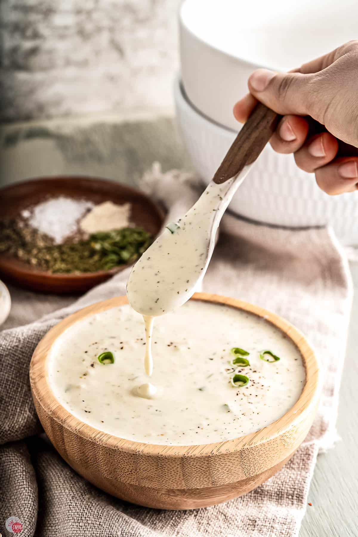 ranch sauce in a wood bowl with a spoon