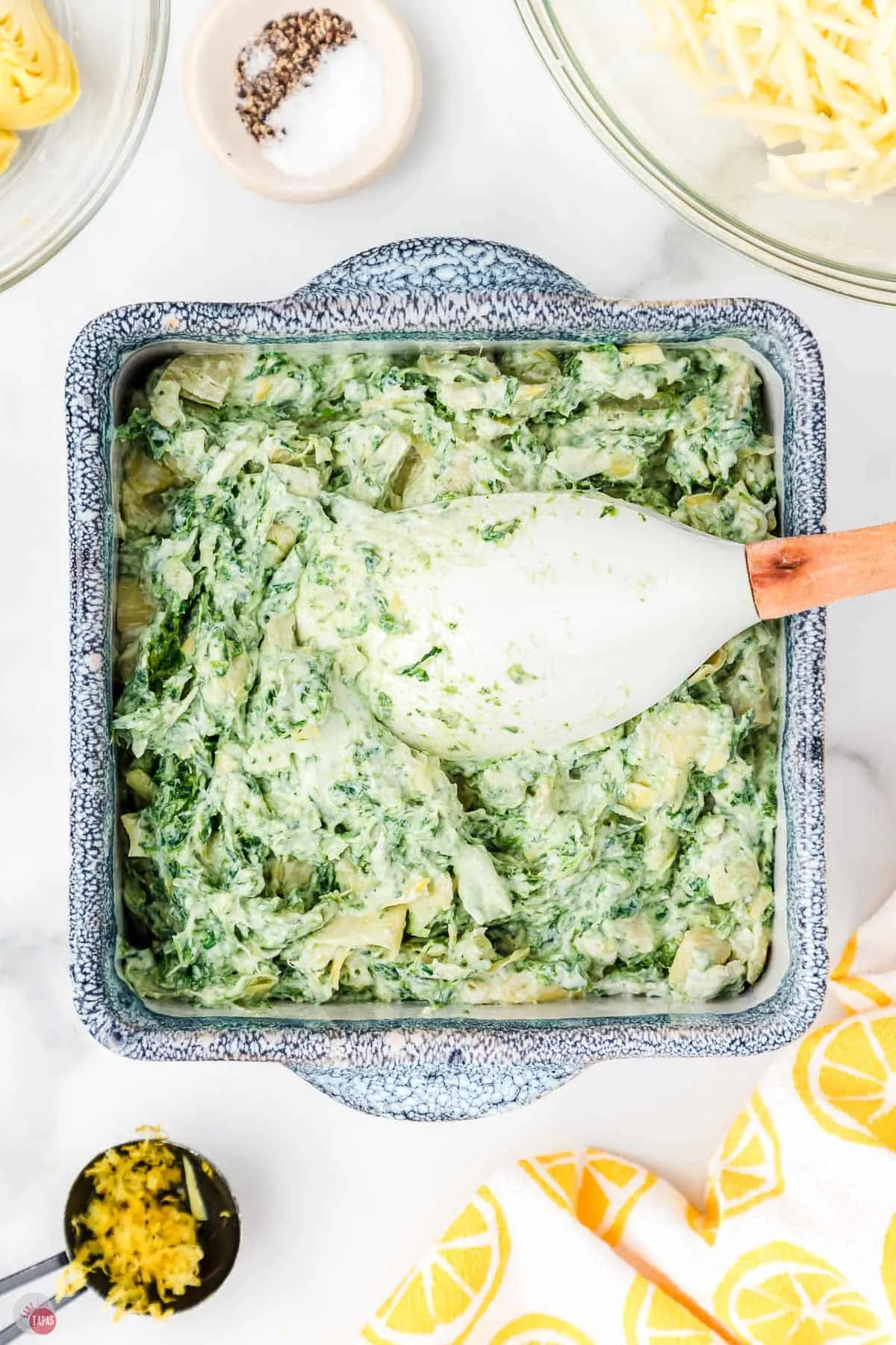 a good dip made of spinach in a square dish with spatula