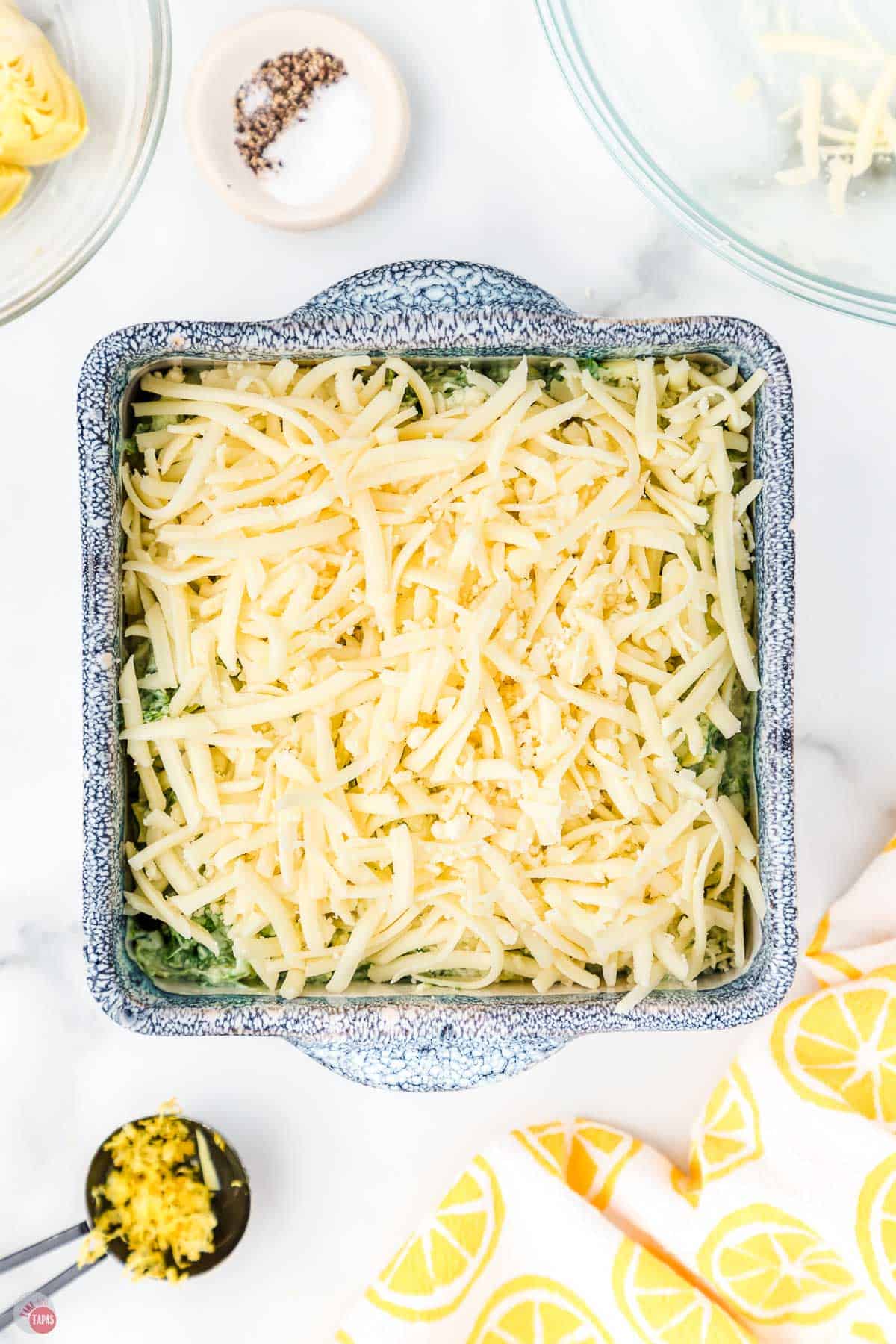 layer of shredded cheese in a blue bowl