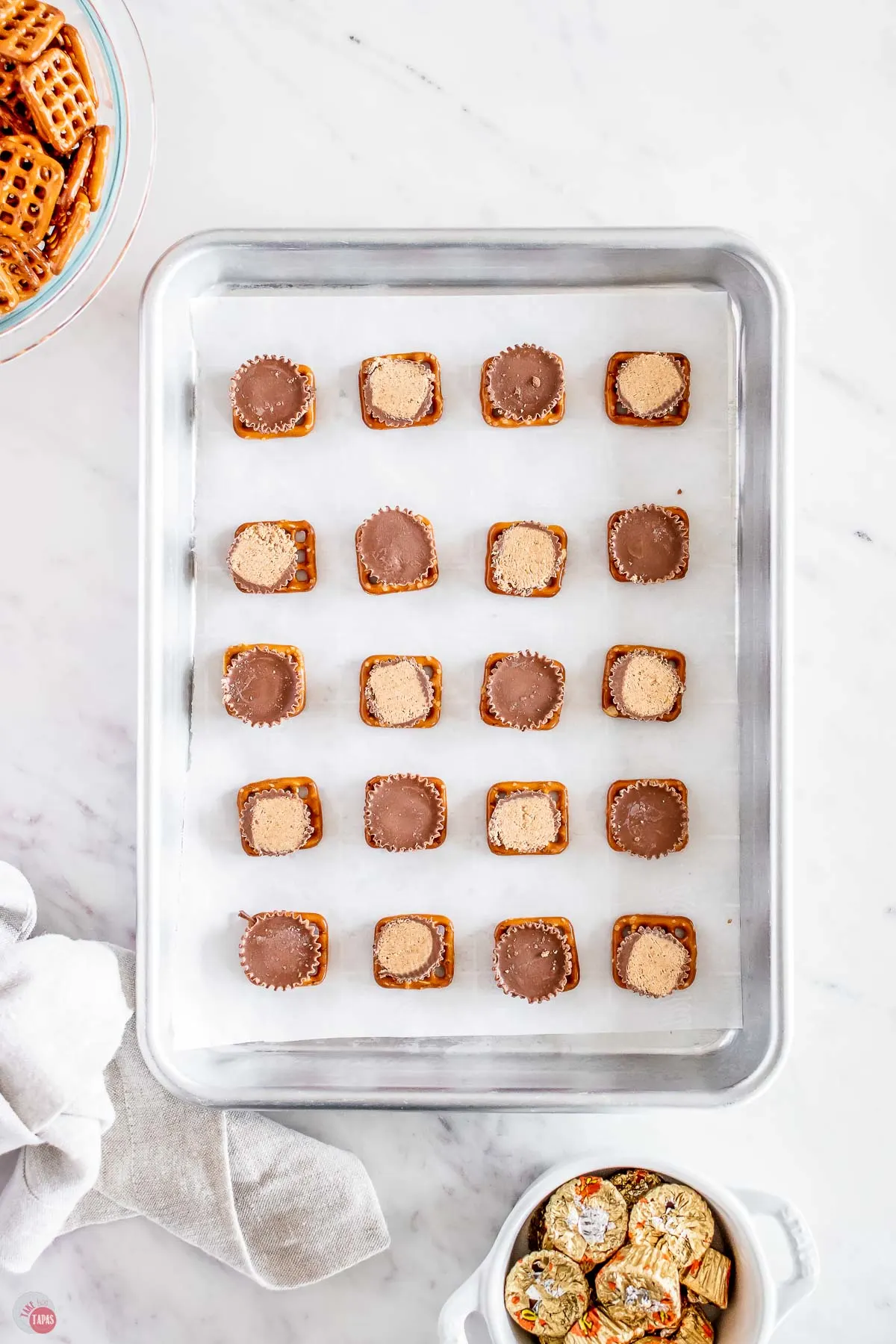 pretzels and peanut butter cups on parchment paper