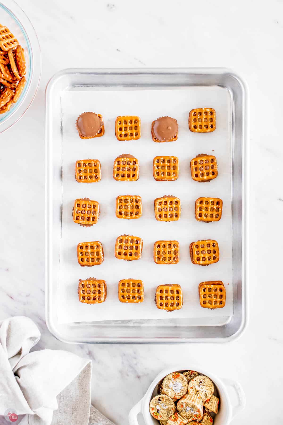 pretzel sandwiches on a baking sheet