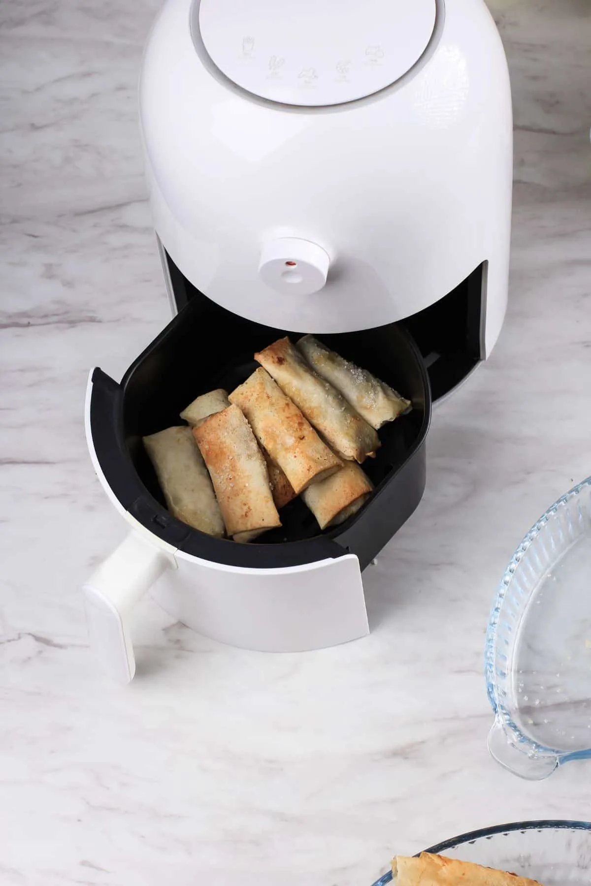 air fryer with egg rolls in it