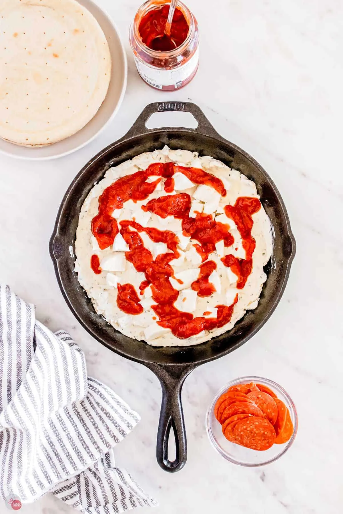 jar of pizza sauce on skillet with cheese