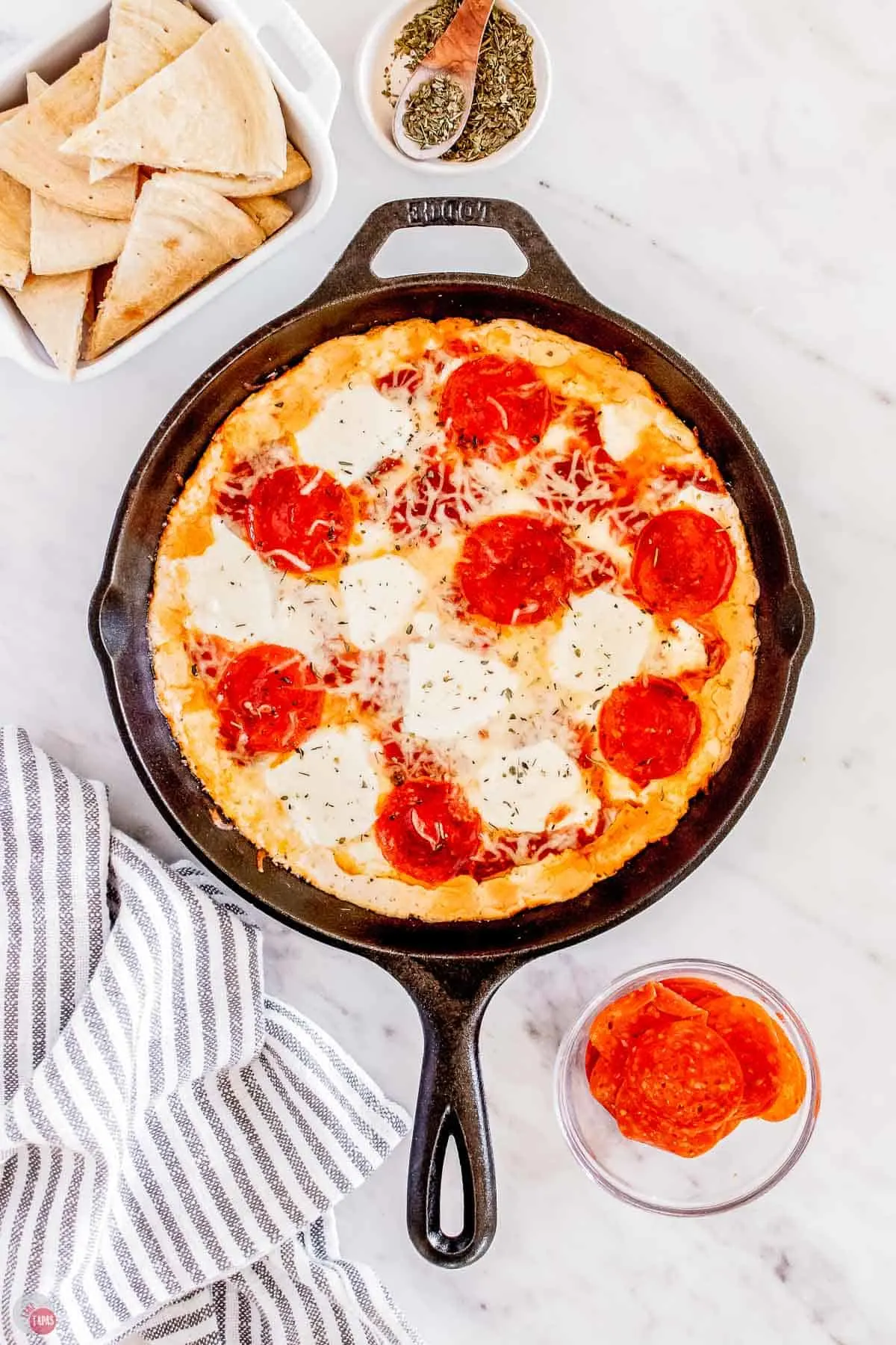 savory pepperoni cheesy party dip in a shallow baking dish