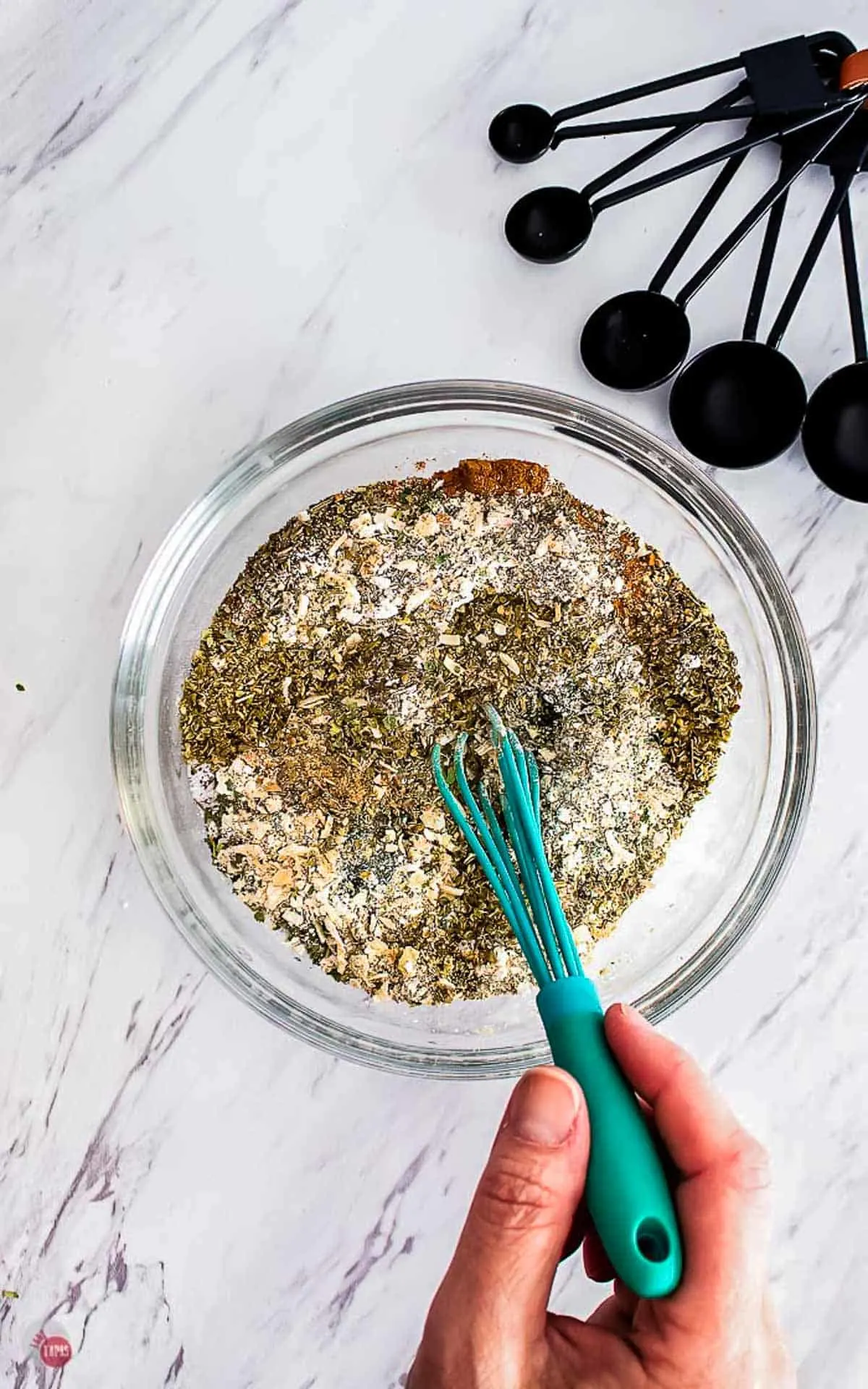 bowl of spices and small blue whisk