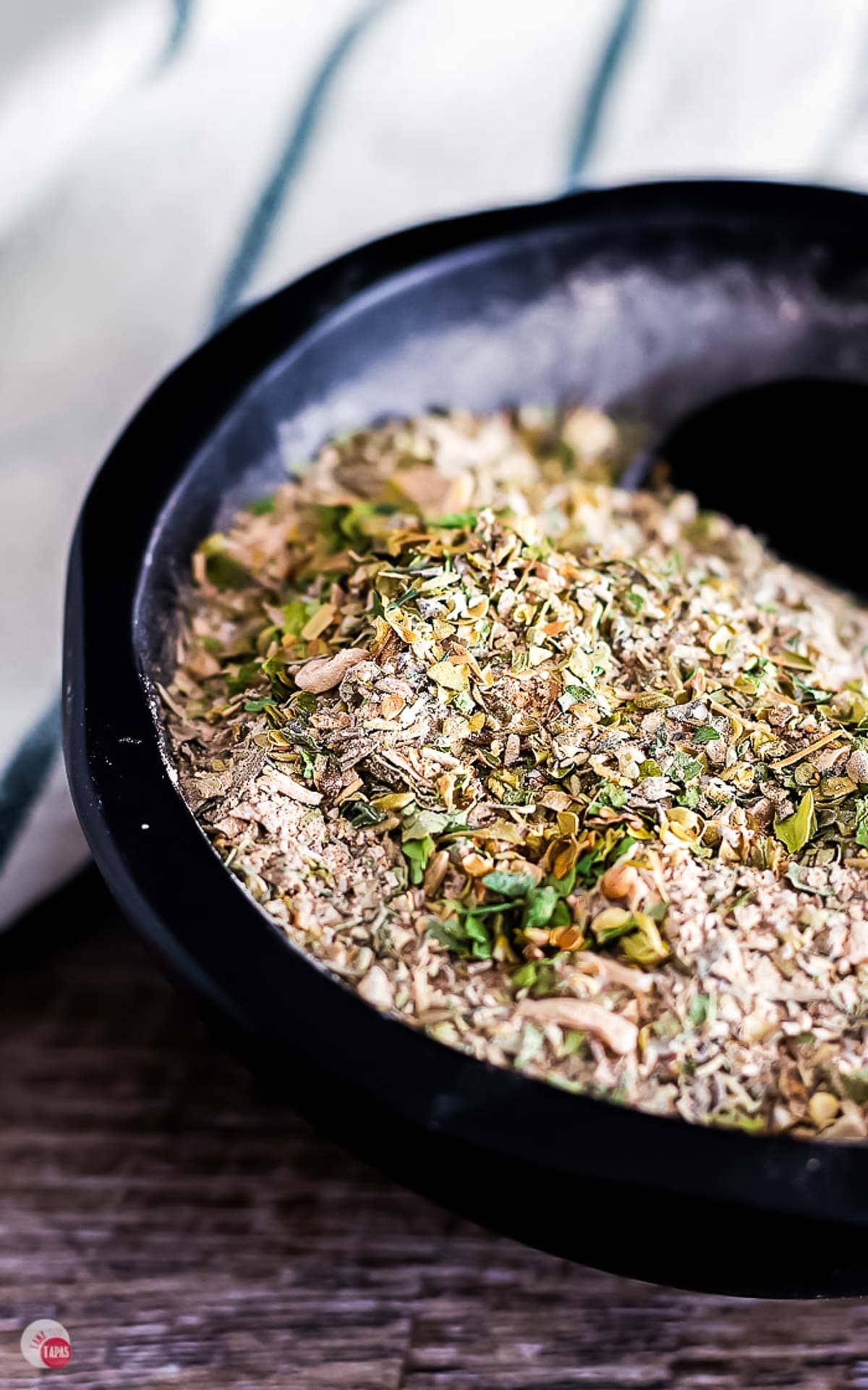 mediterranean seasoning in a bowl with a measuring spoon