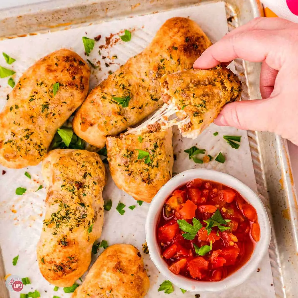 tray of taco breadsticks with lots of cheese