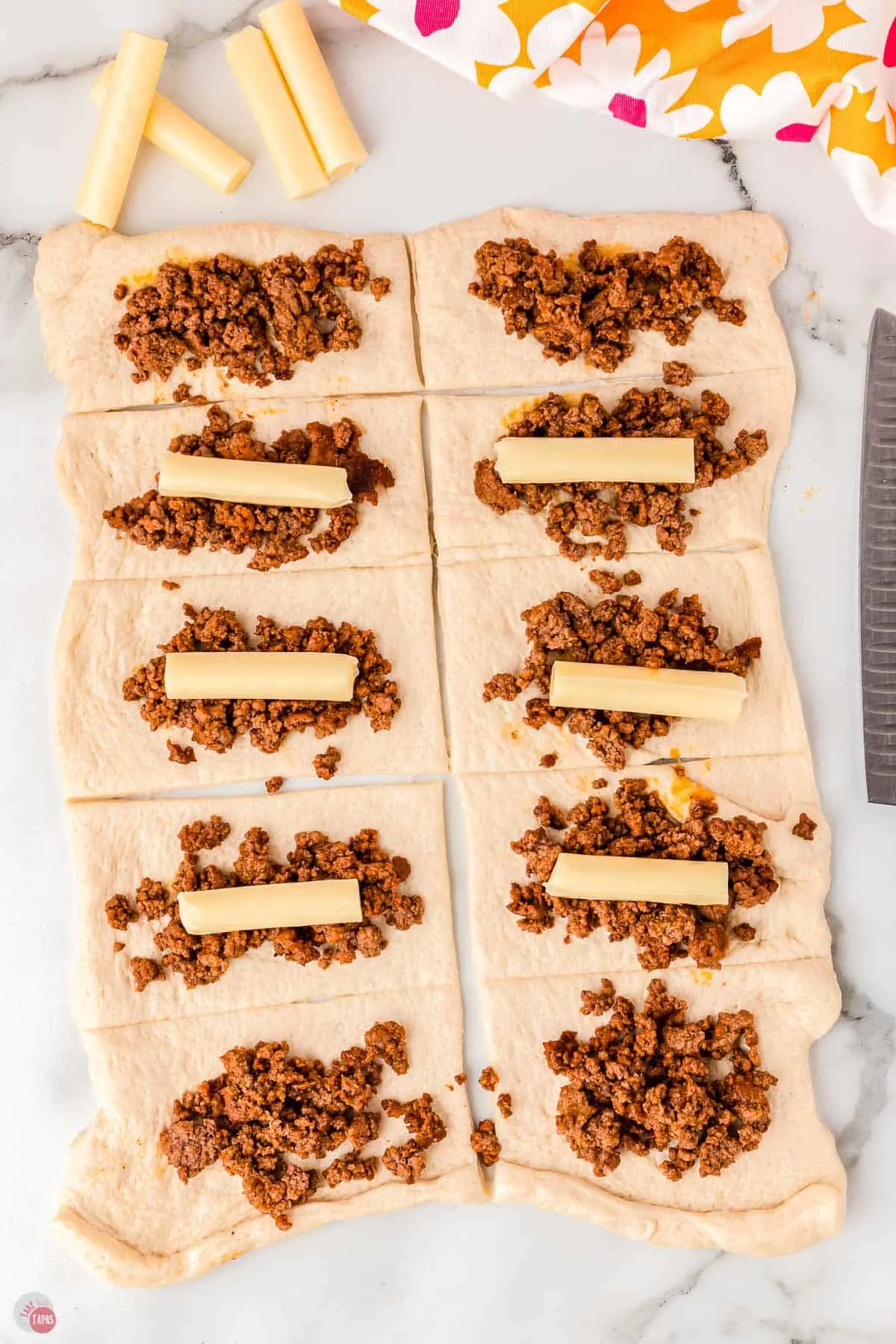 half cheese stick and ground beef on  dough