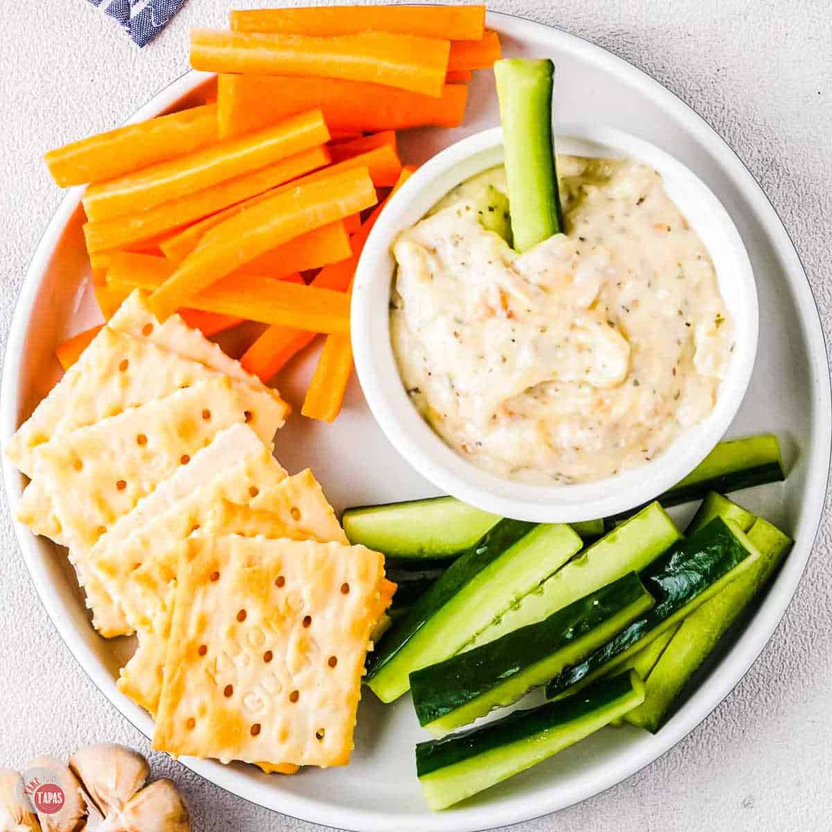 bowl of garlic dip with vegetable sticks