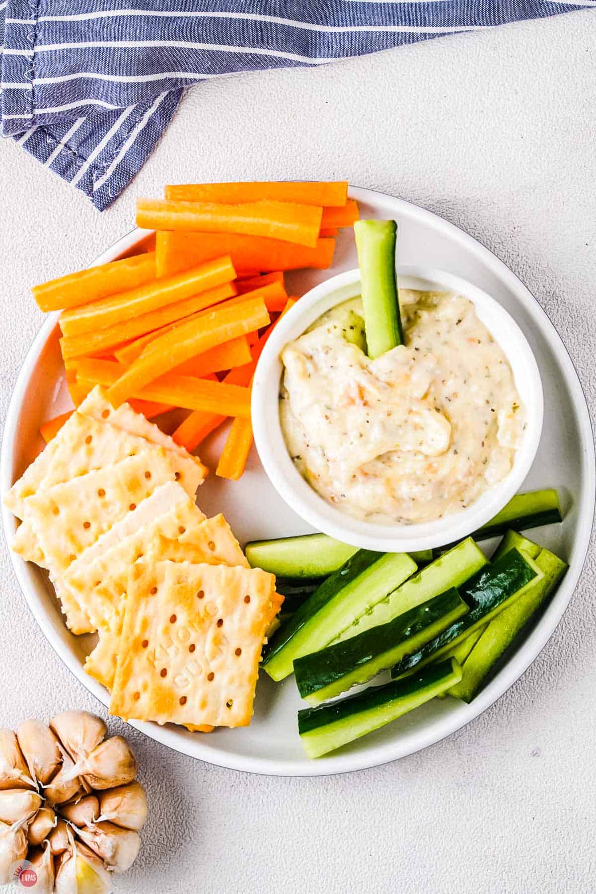 roasted garlic dip with vegetables on a plate