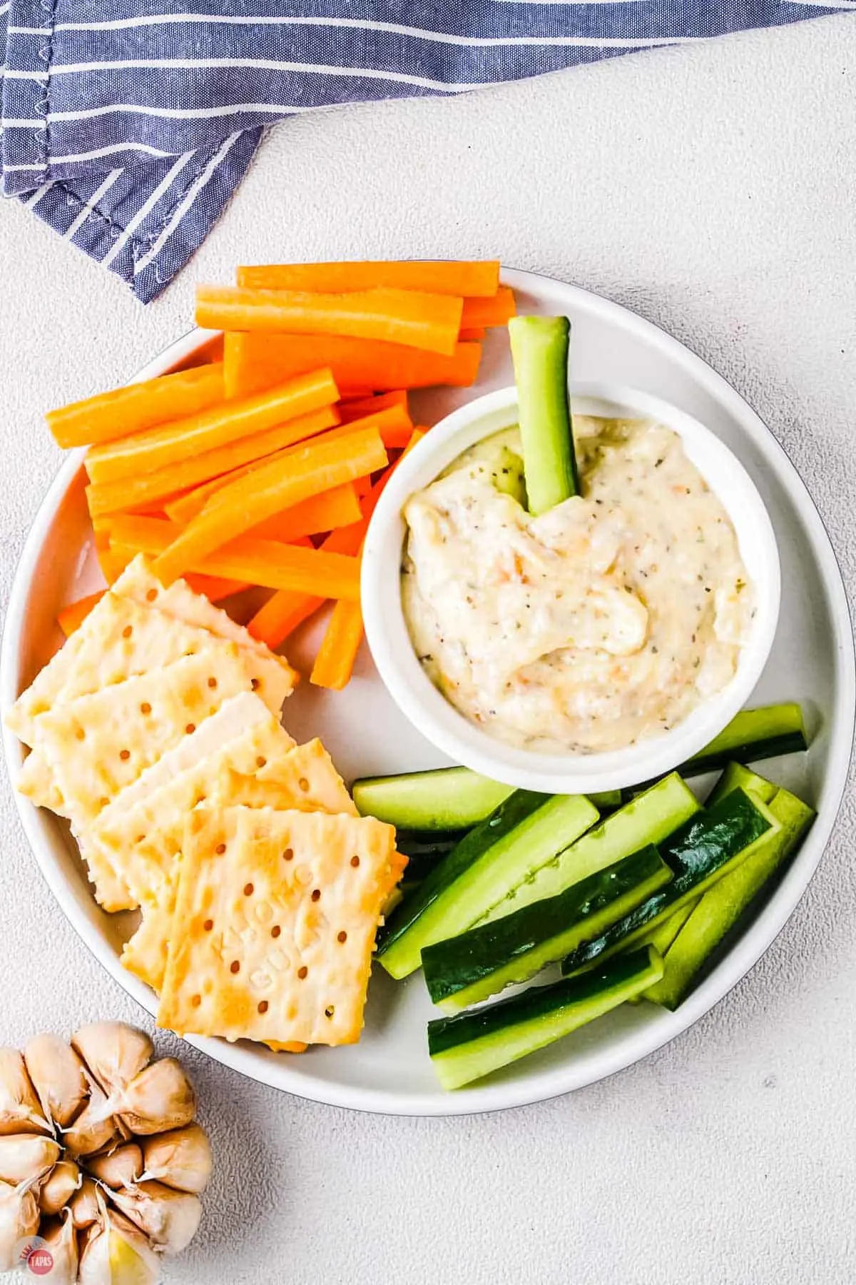 roasted garlic dip with vegetables on a plate