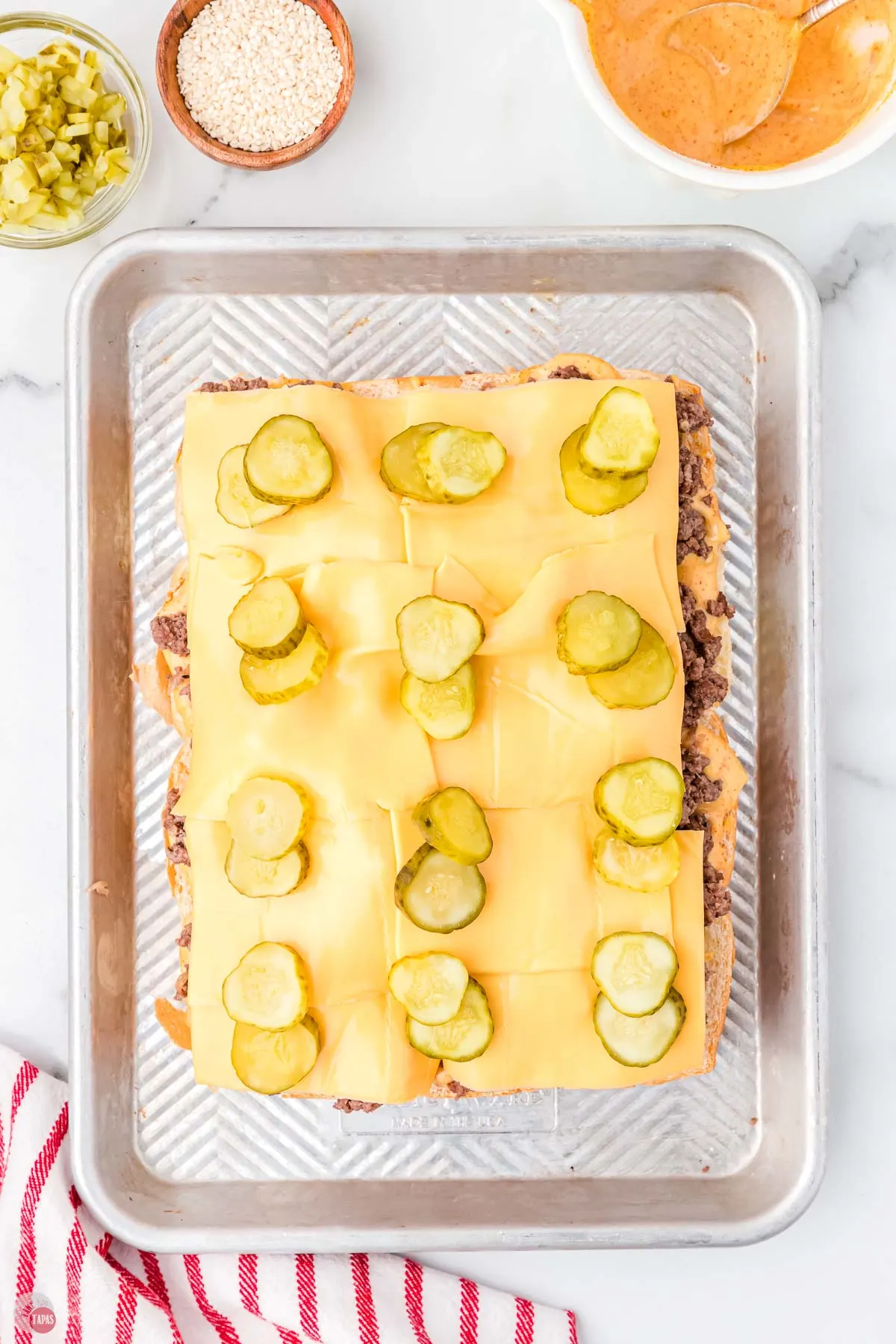 slices of american cheese and pickles on a tray