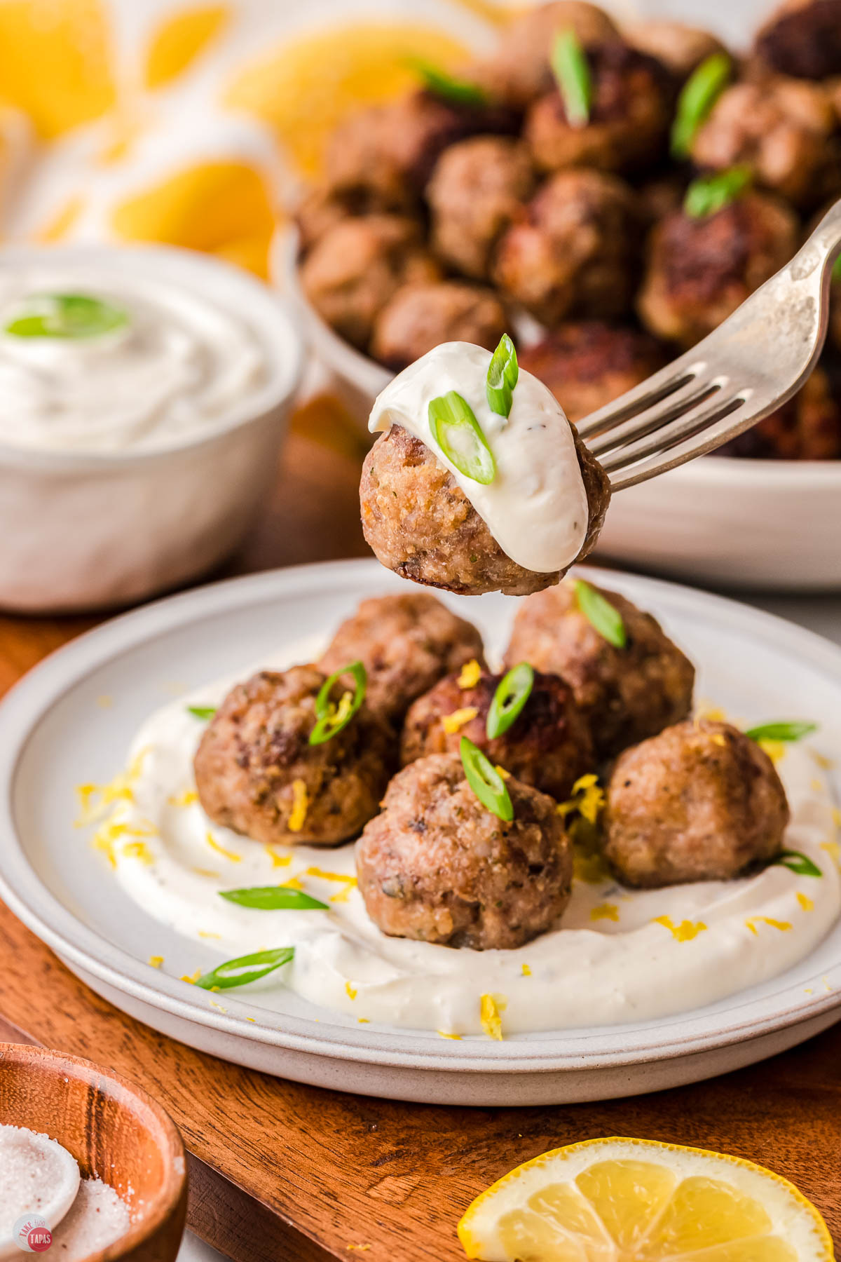 fork with lamb meatball and tzatziki sauce