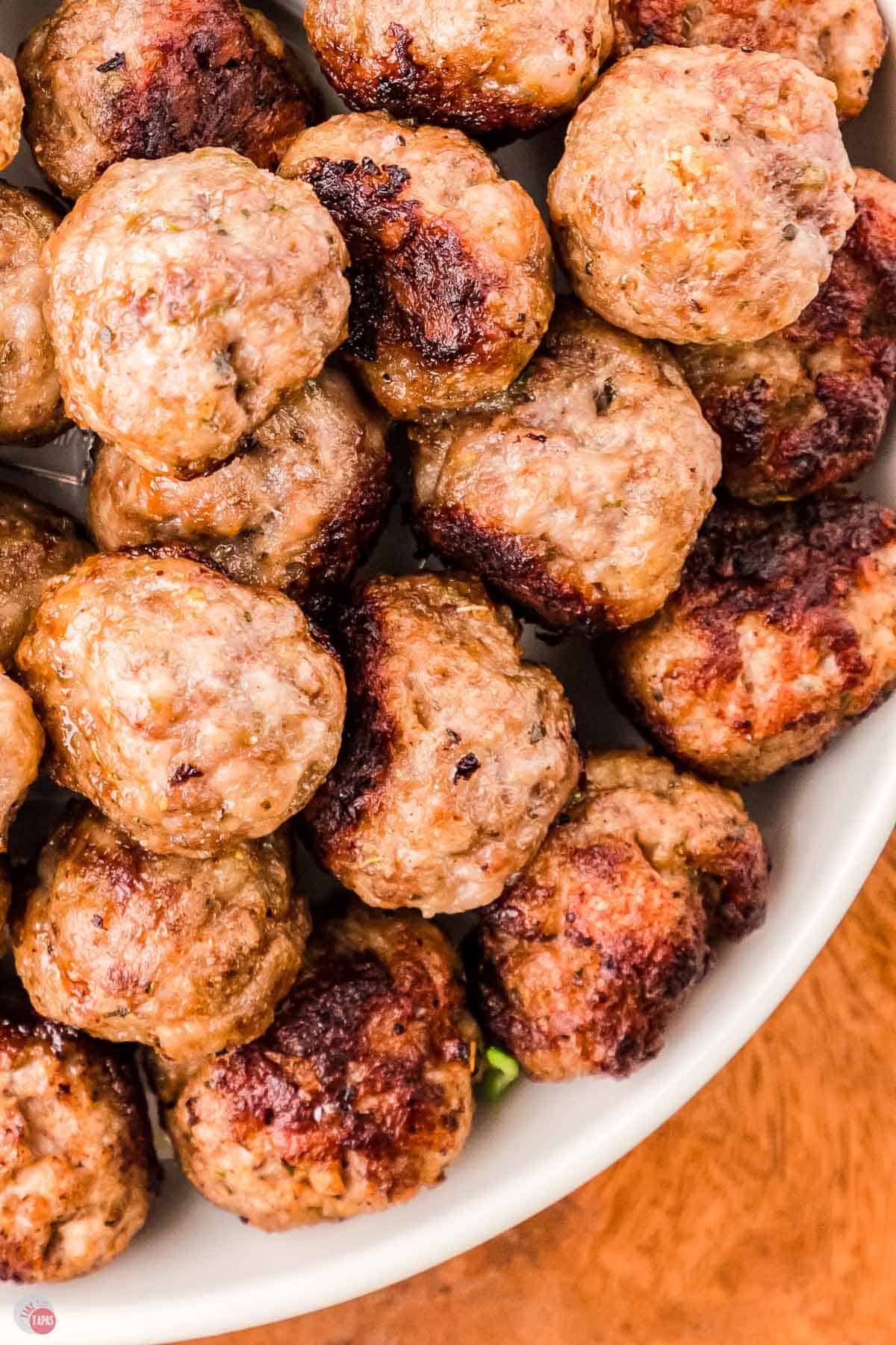 close up of lamb meatballs in a white bowl