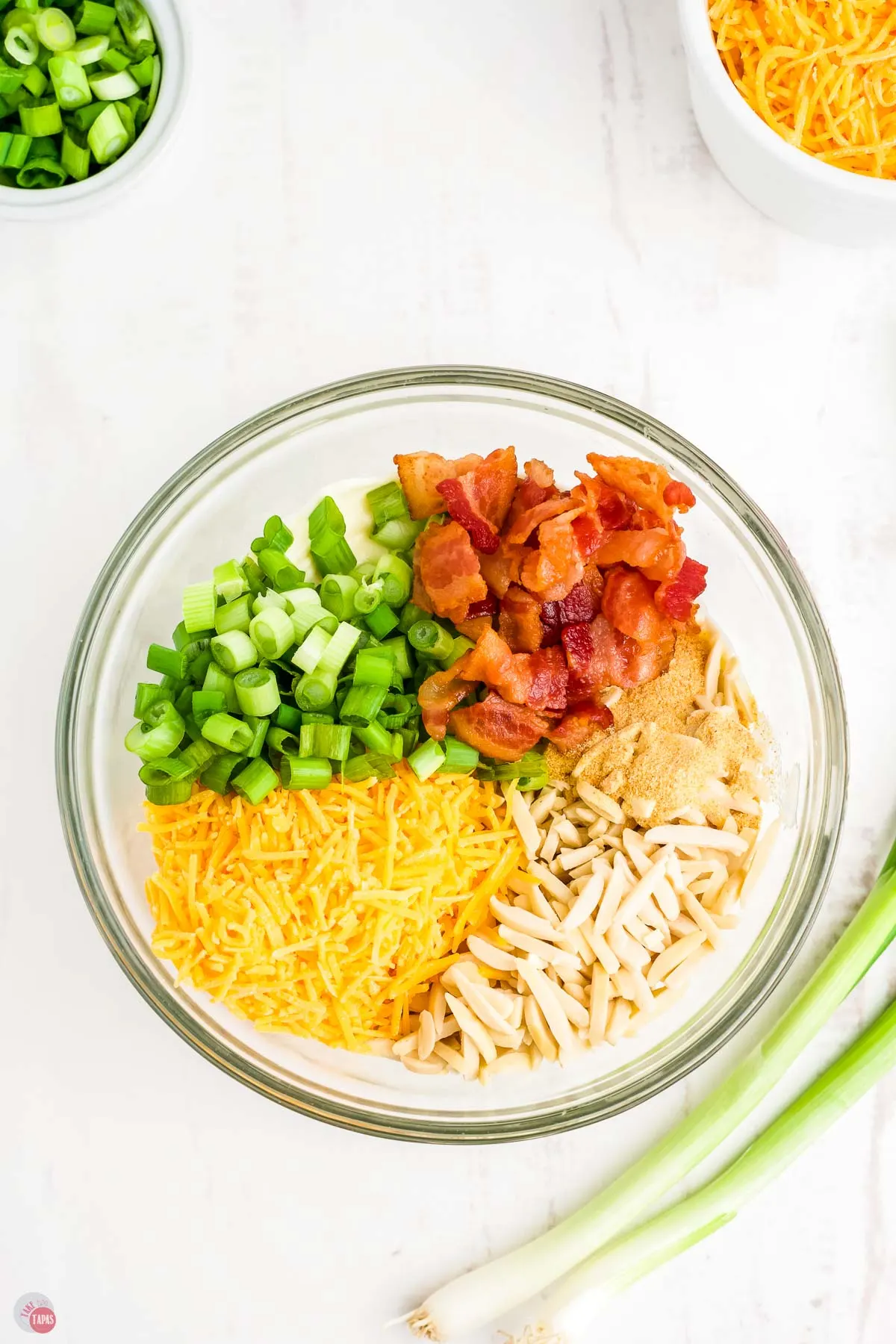 bacon, cheese, green onions in a bowl