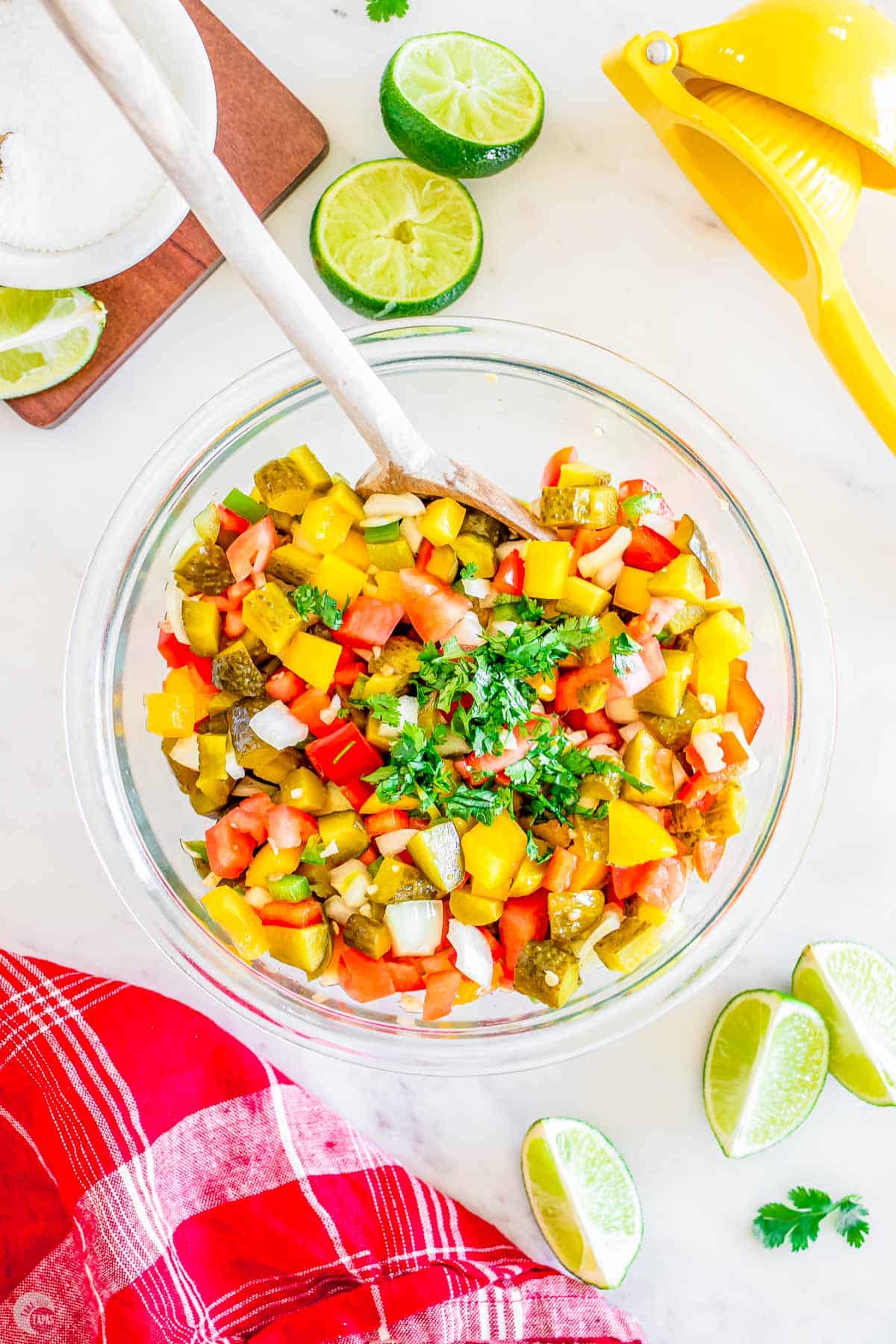 bowl of pickle de gallo with limes around it