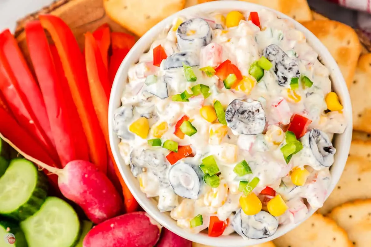 bowl of poolside dip with bell peppers and radishes