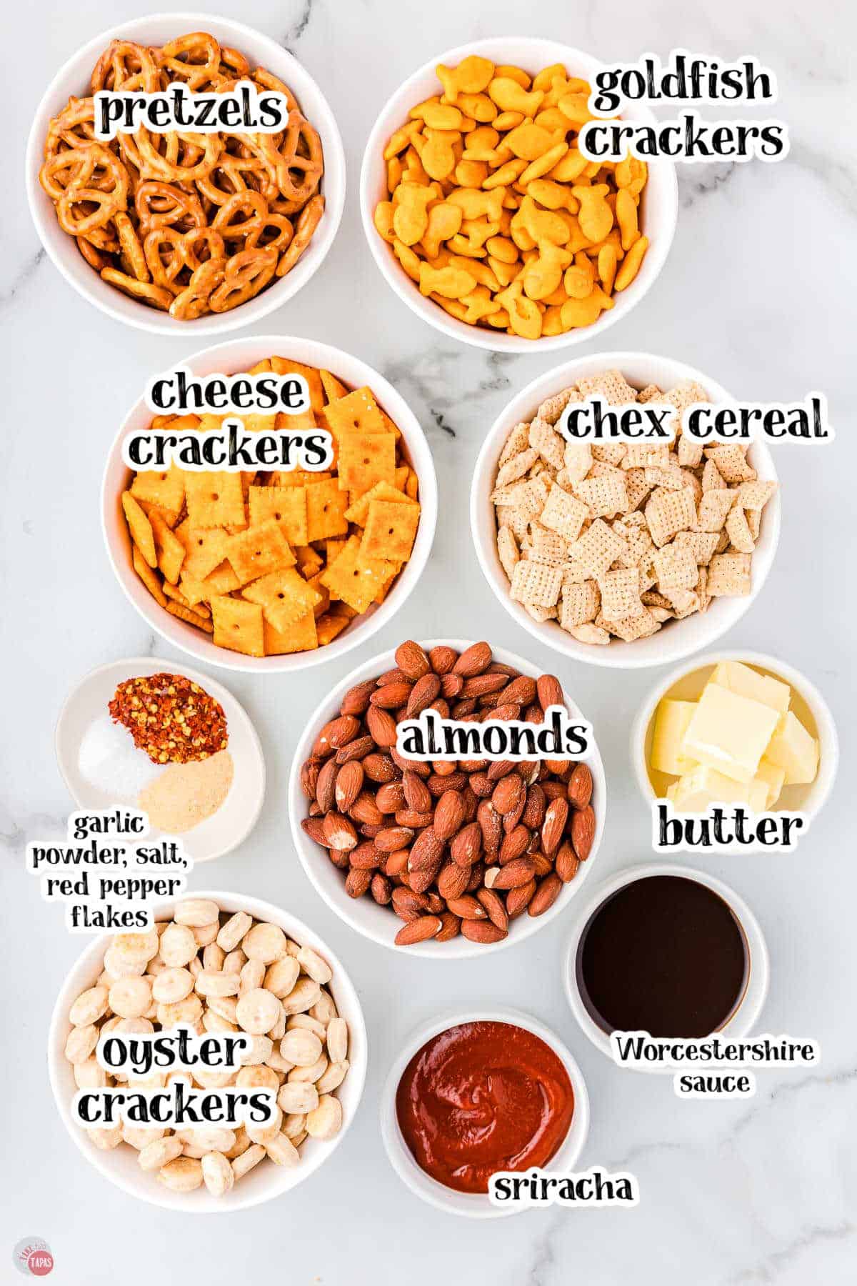 ingredients for spicy chex mix in individual bowls