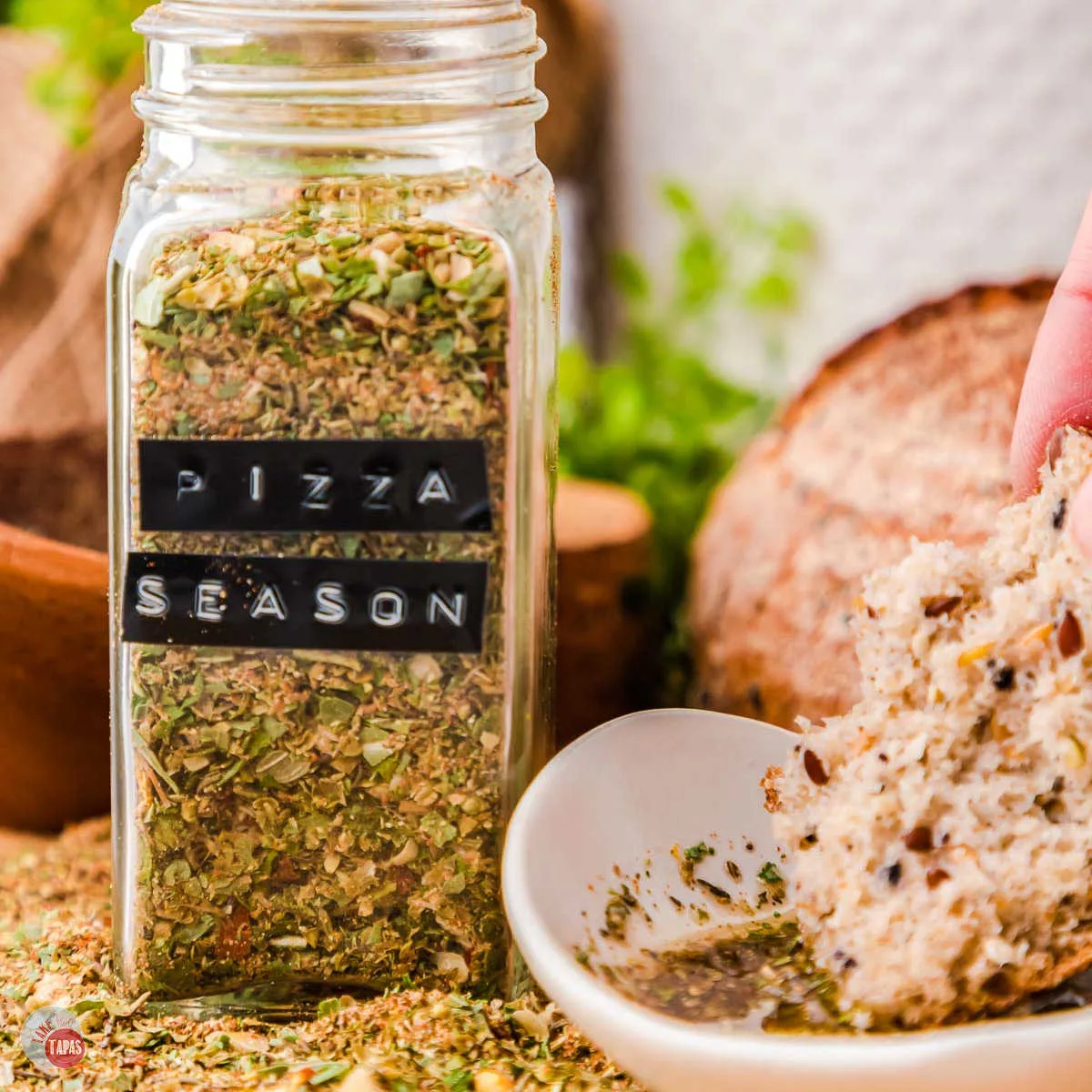 pizza seasoning in a labeled jar with bread and olive oil