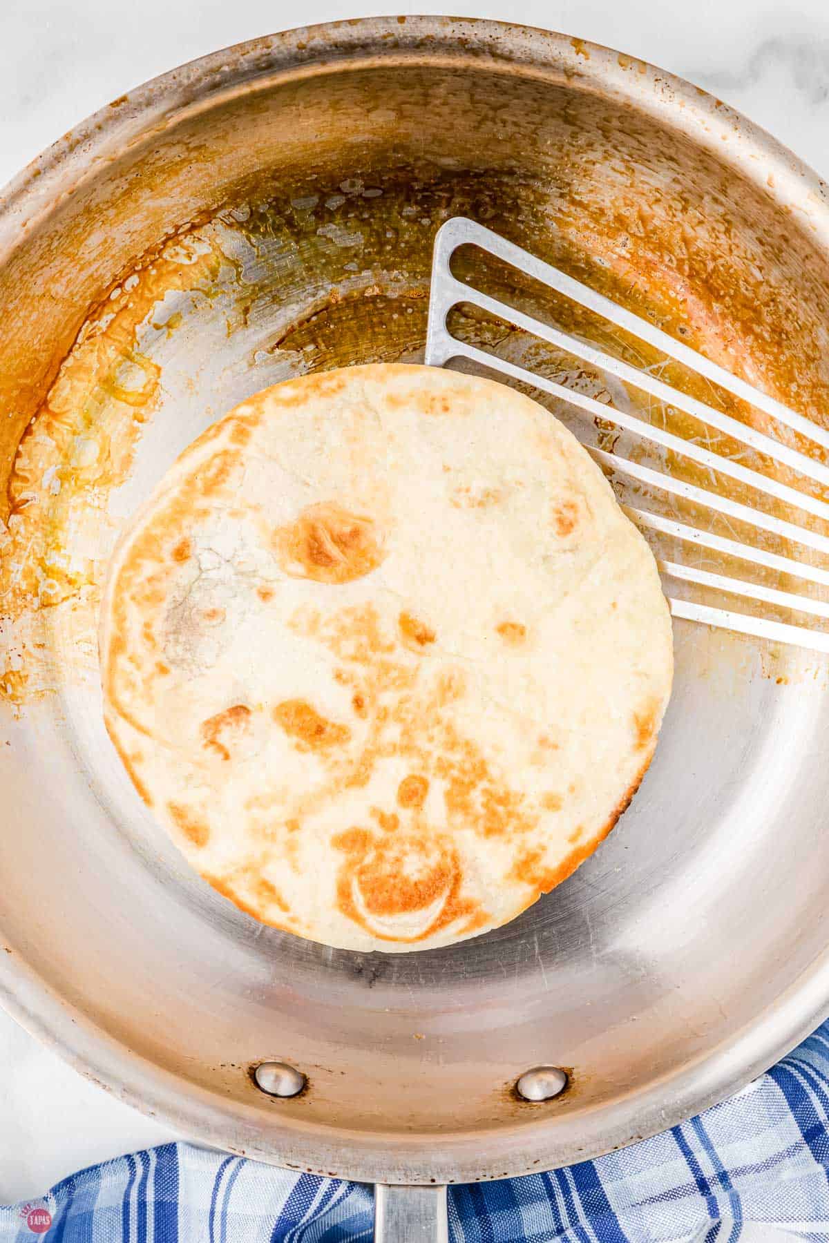 flour tortilla frying in a pan