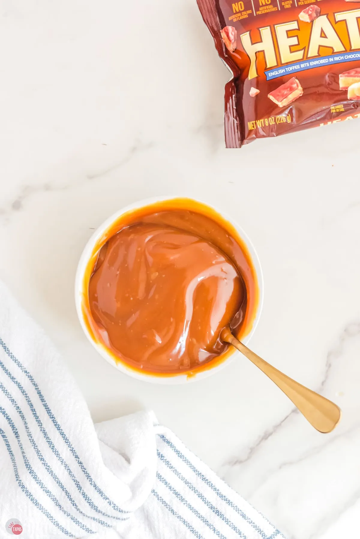 thick caramel sauce in a cup with a spoon