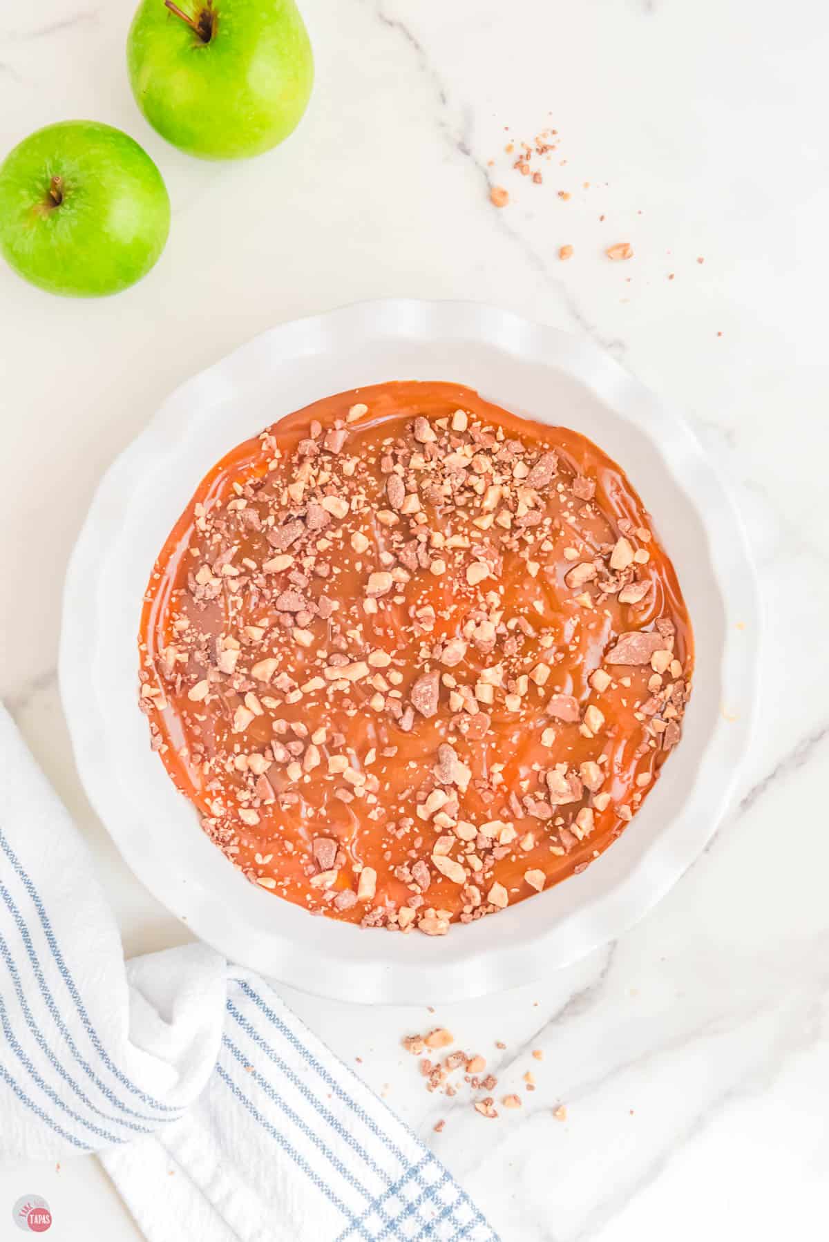 candy bar bits sprinkled on top of the caramel layer