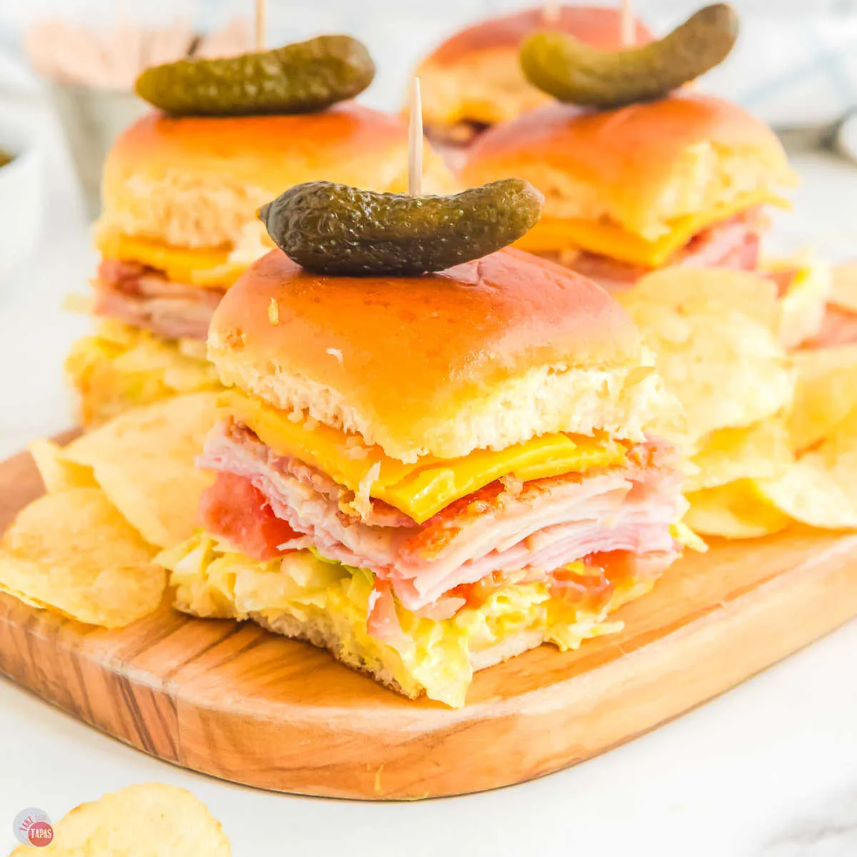 plate of club sliders with chips and pickles