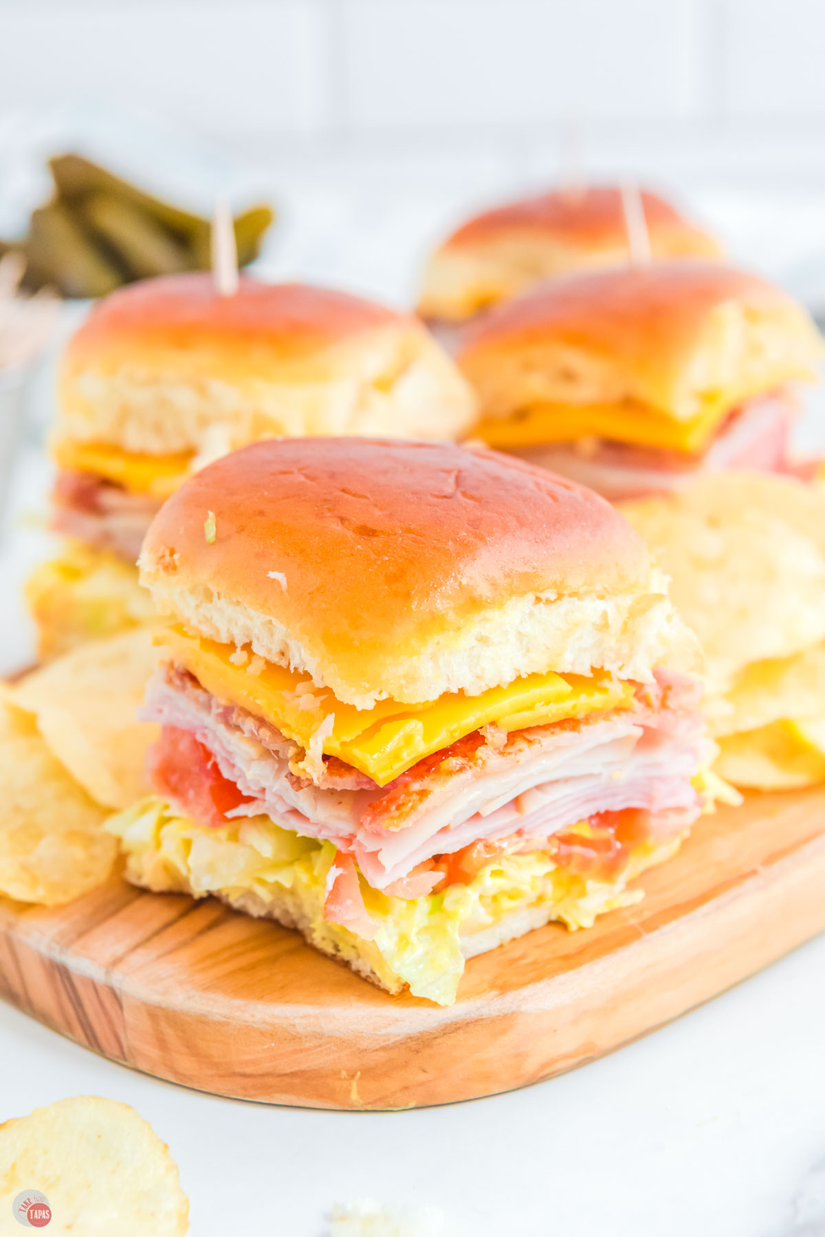 ham and turkey sliders with bacon on a plate