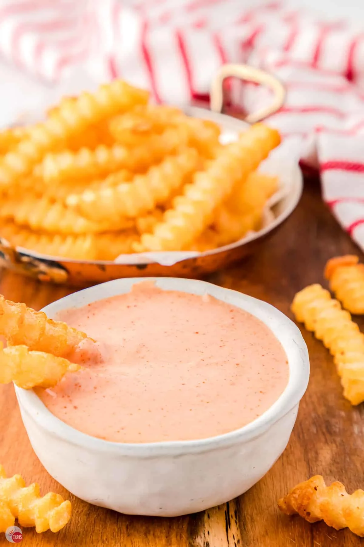 bowl of sauce and plate of fries