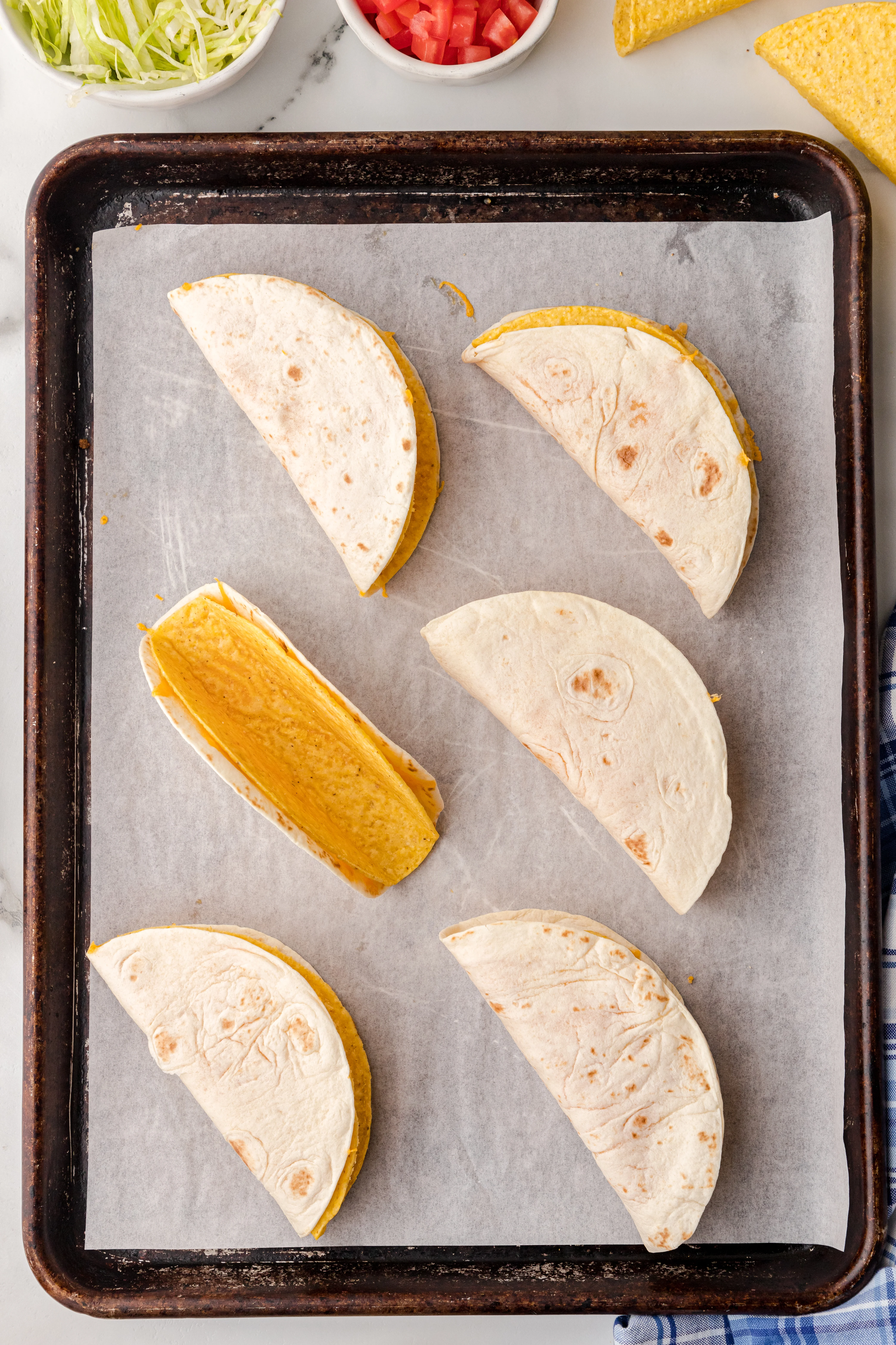 6 tacos on a baking sheet