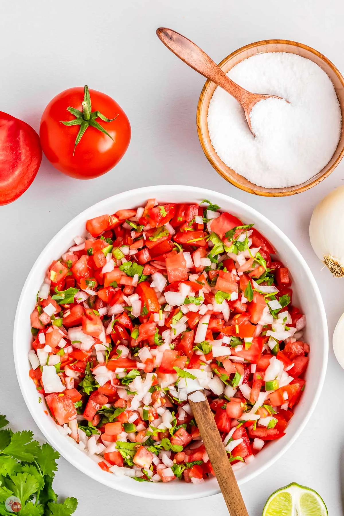 fresh chopped pico de gallo in a bowl with a spatula