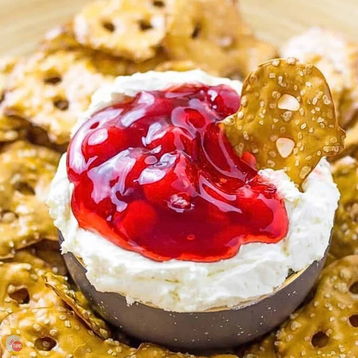 bowl of dip topped with cherry pie filling