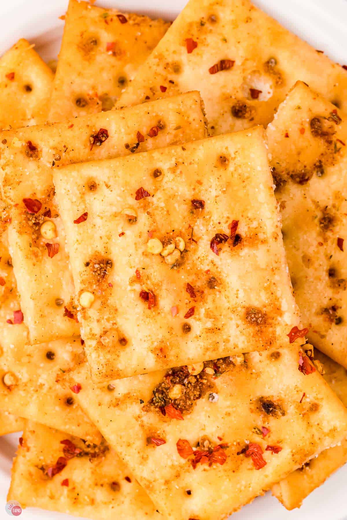 close up of saltine crackers with spices on them