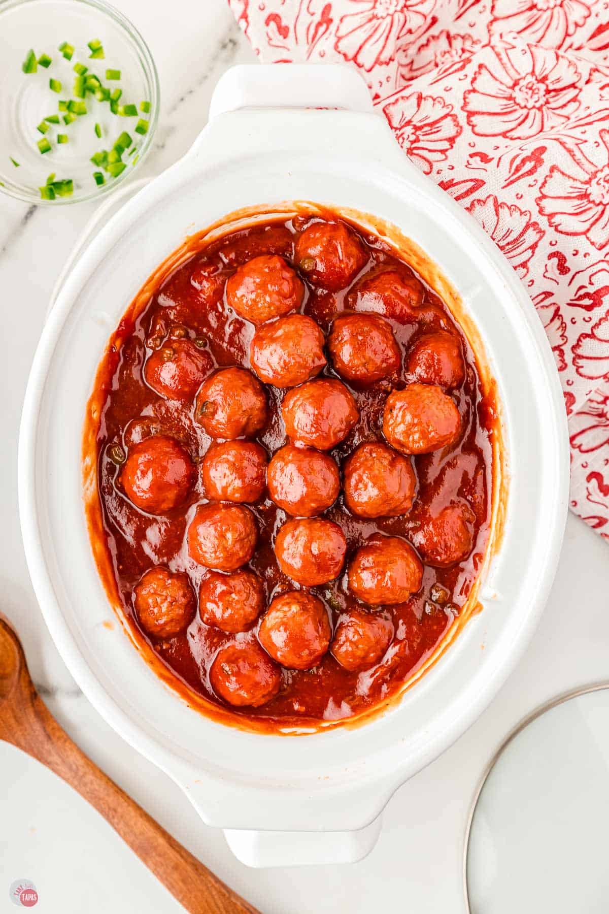 saucy meatballs in a white crock pot