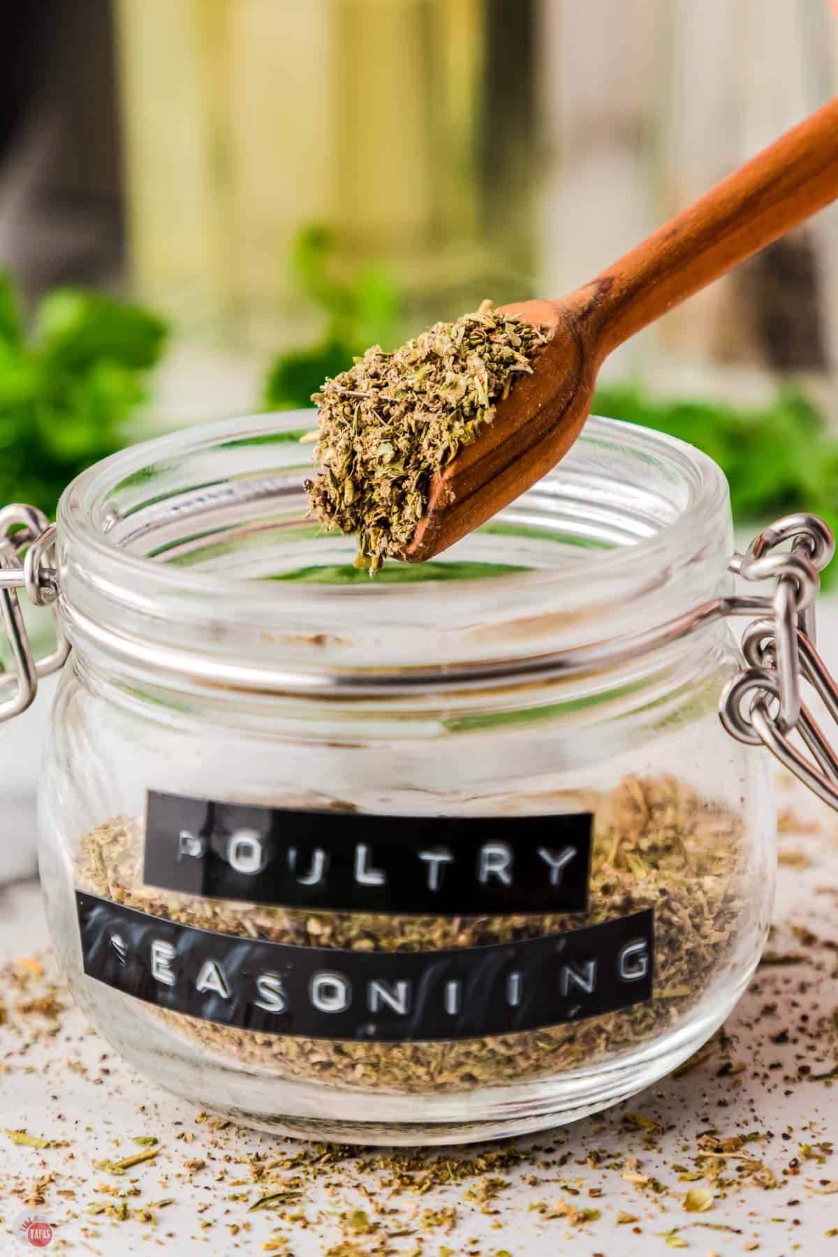 jar of seasoning and herbs with a wood spoon