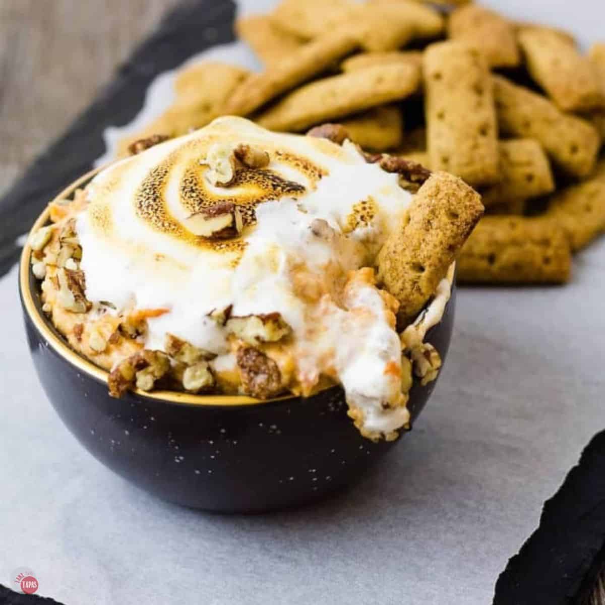 sweet potato souffle dip in a black bowl