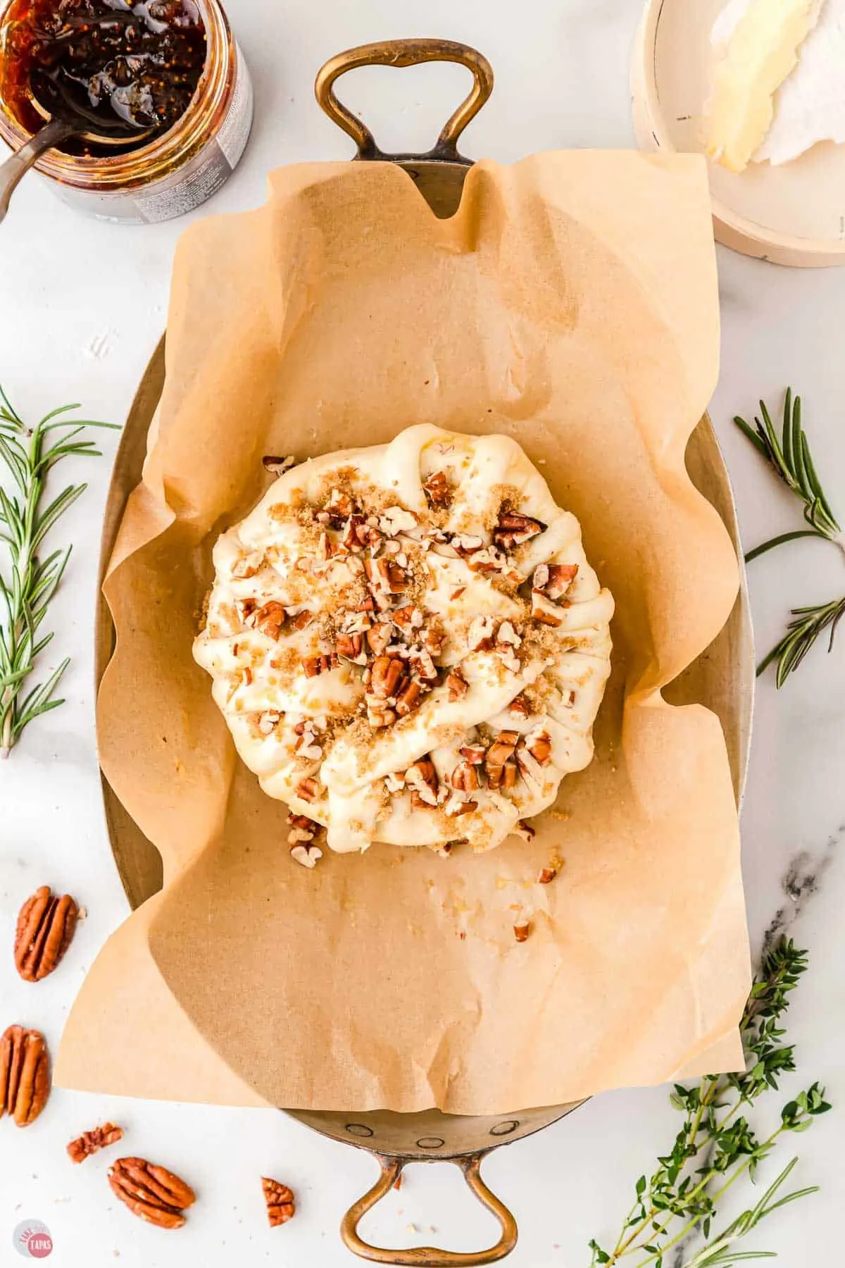 cheese with nuts on a parchment-lines baking sheet