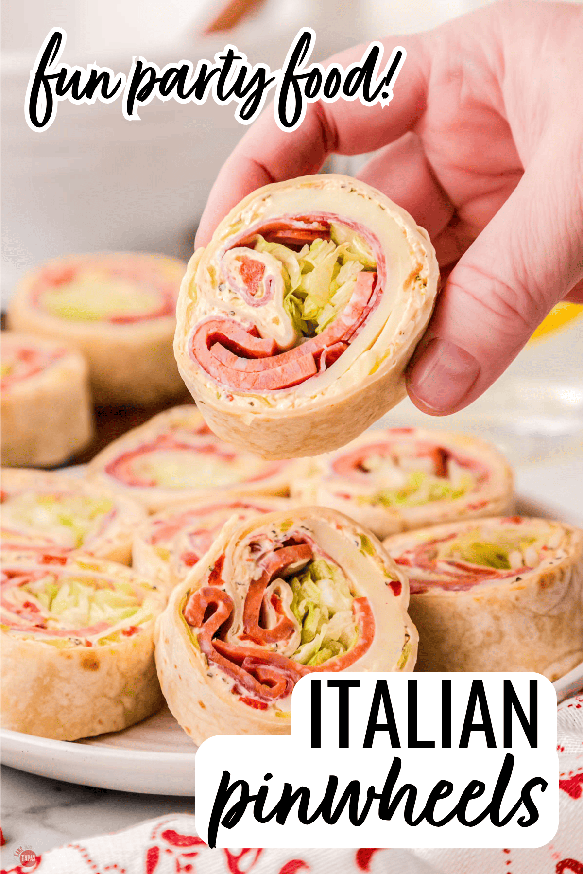 hand holding an Italian roll up sandwich