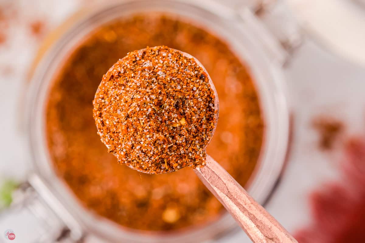 close up of copper measuring spoon with a spice mix in it